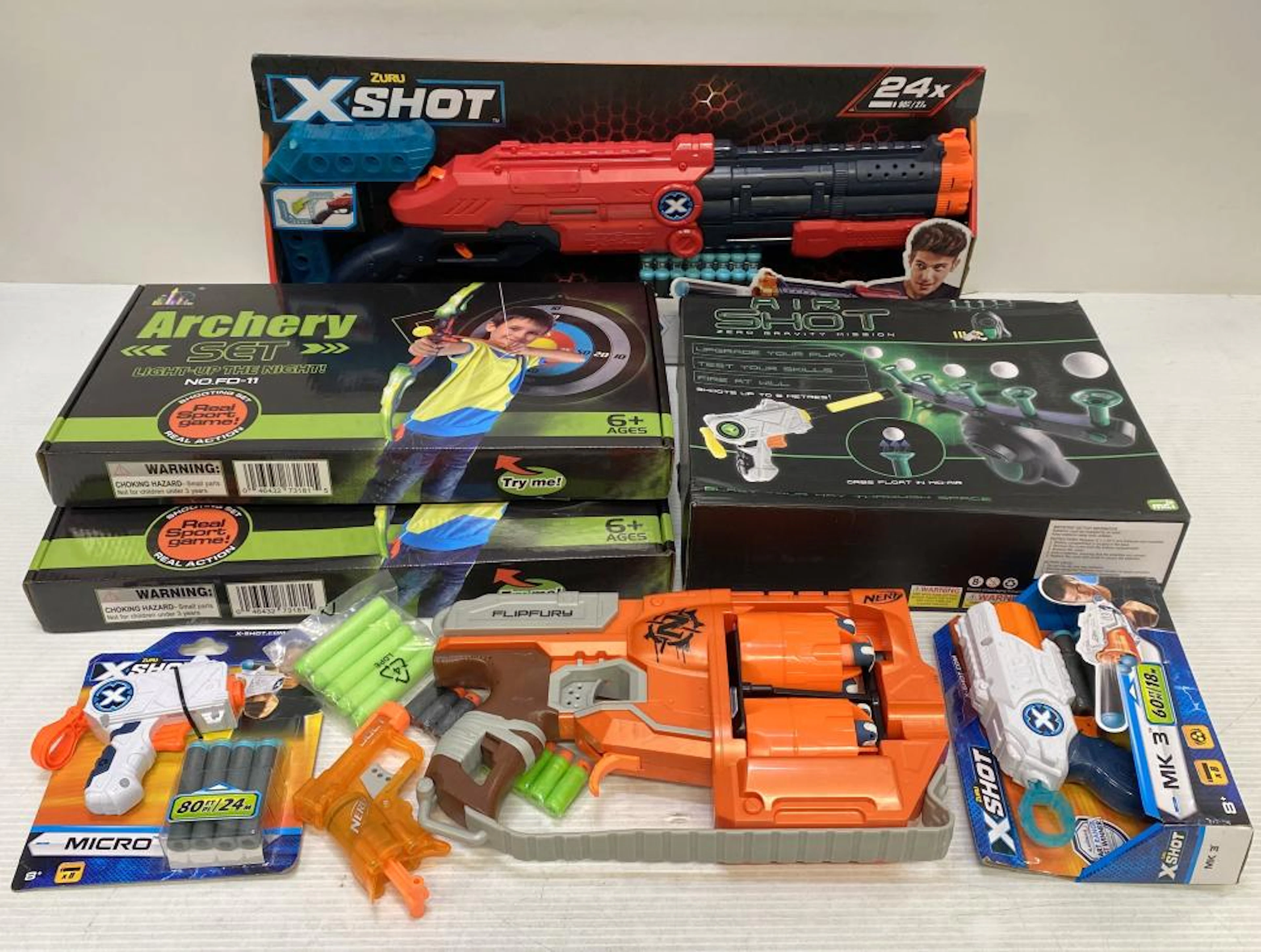 A group of toy guns marked Nerf etc.