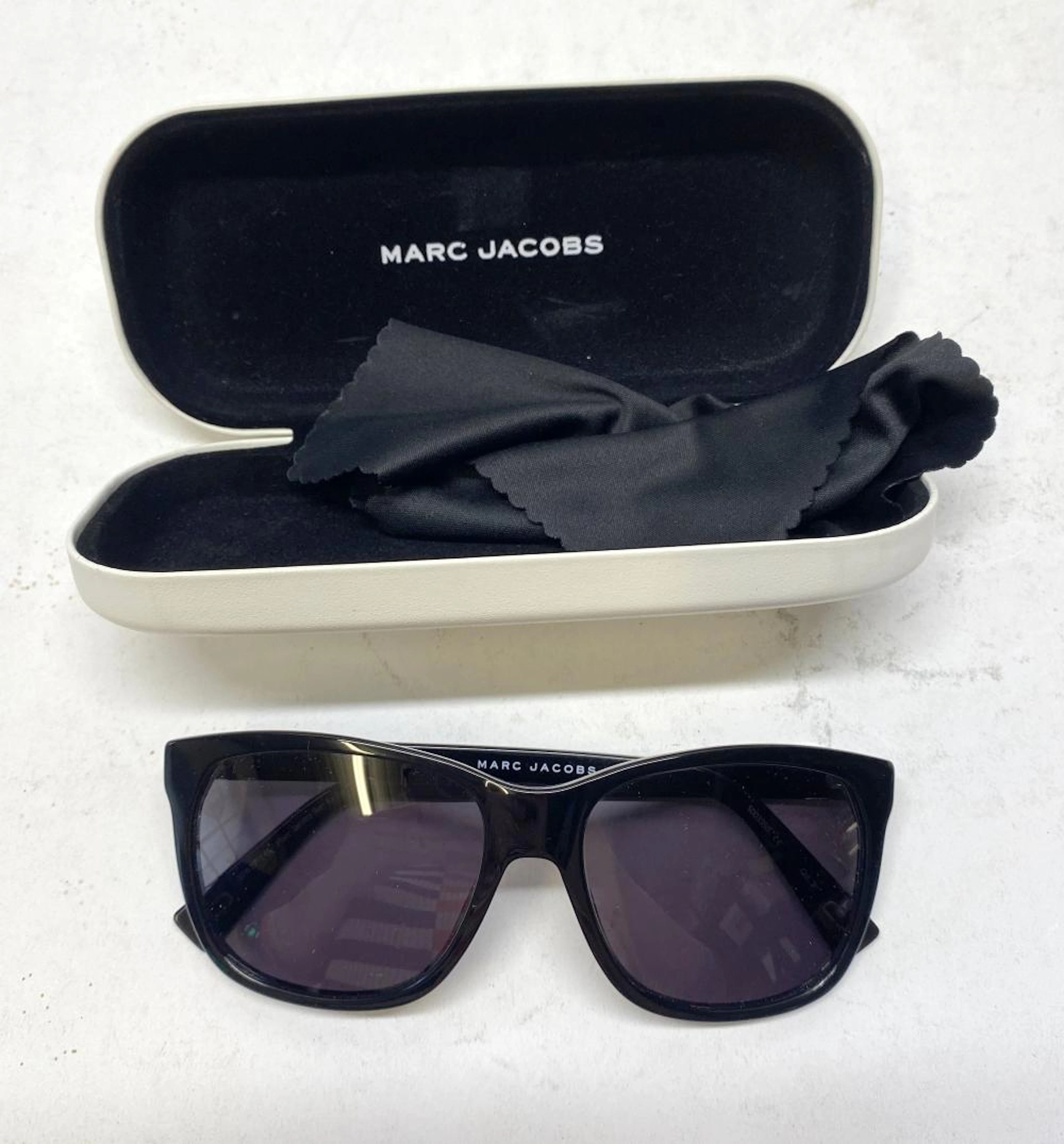 A pair of sunglasses marked Marc Jacobs