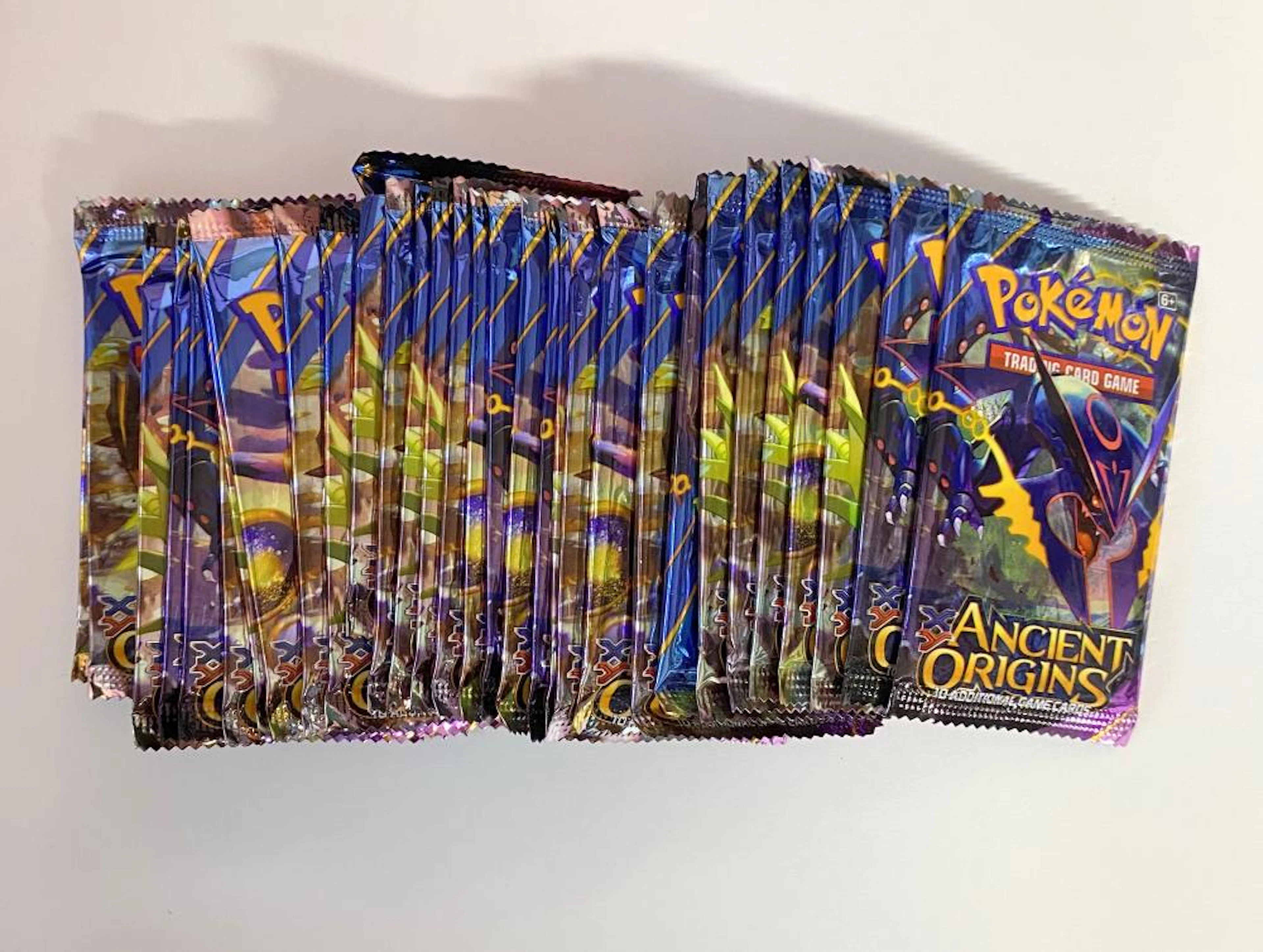 A group of card packs marked Pokémon Ancient Origins etc.