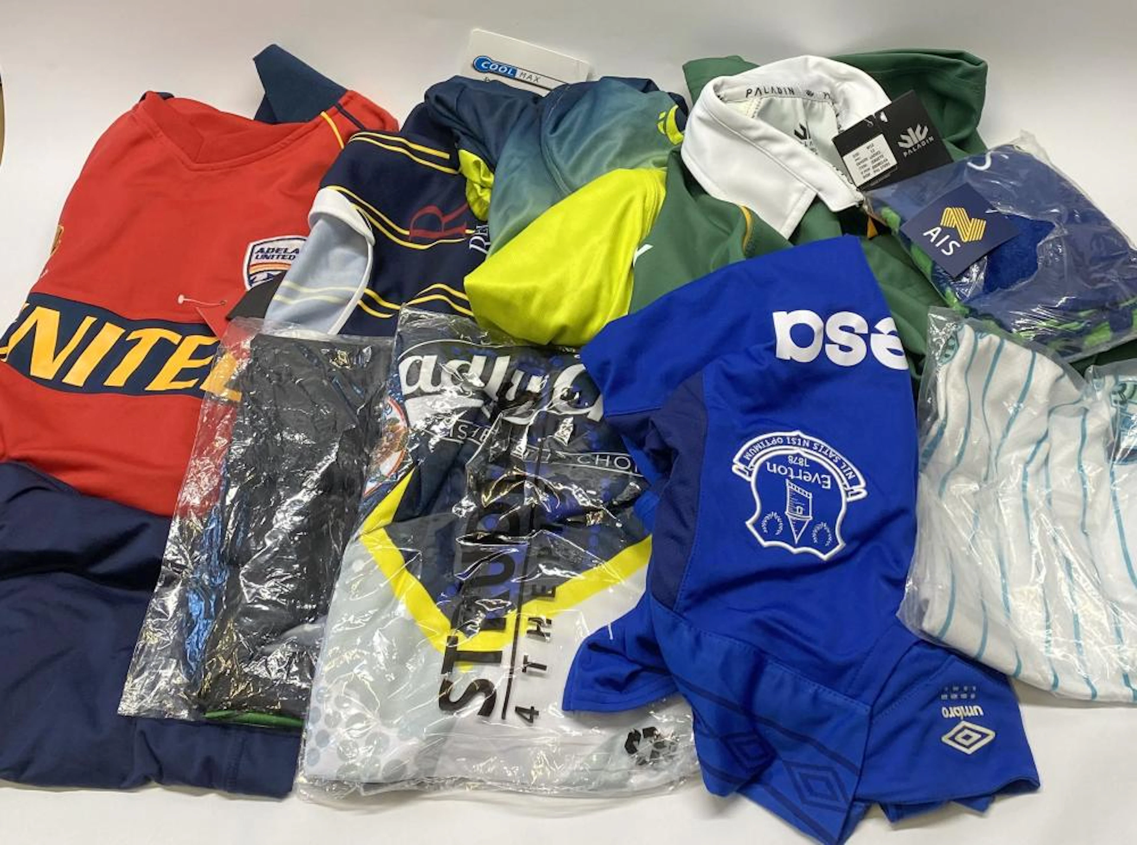 A group of sports uniforms, various styles/sizes