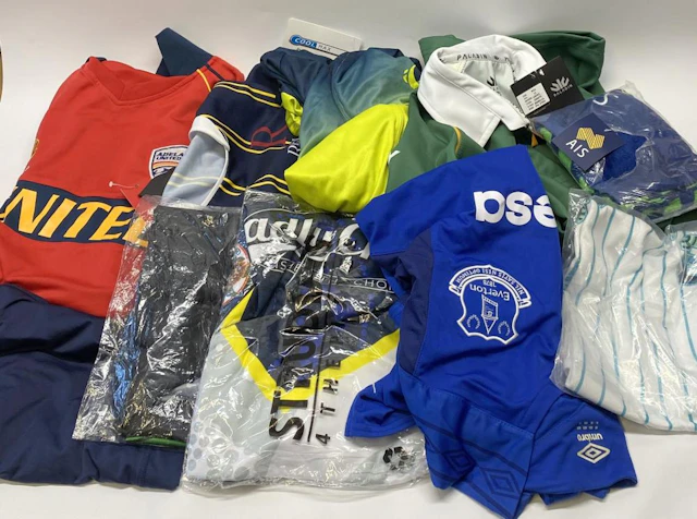 A group of sports uniforms, various styles/sizes