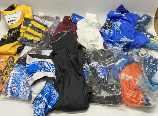 A group of sports uniforms, various styles/sizes