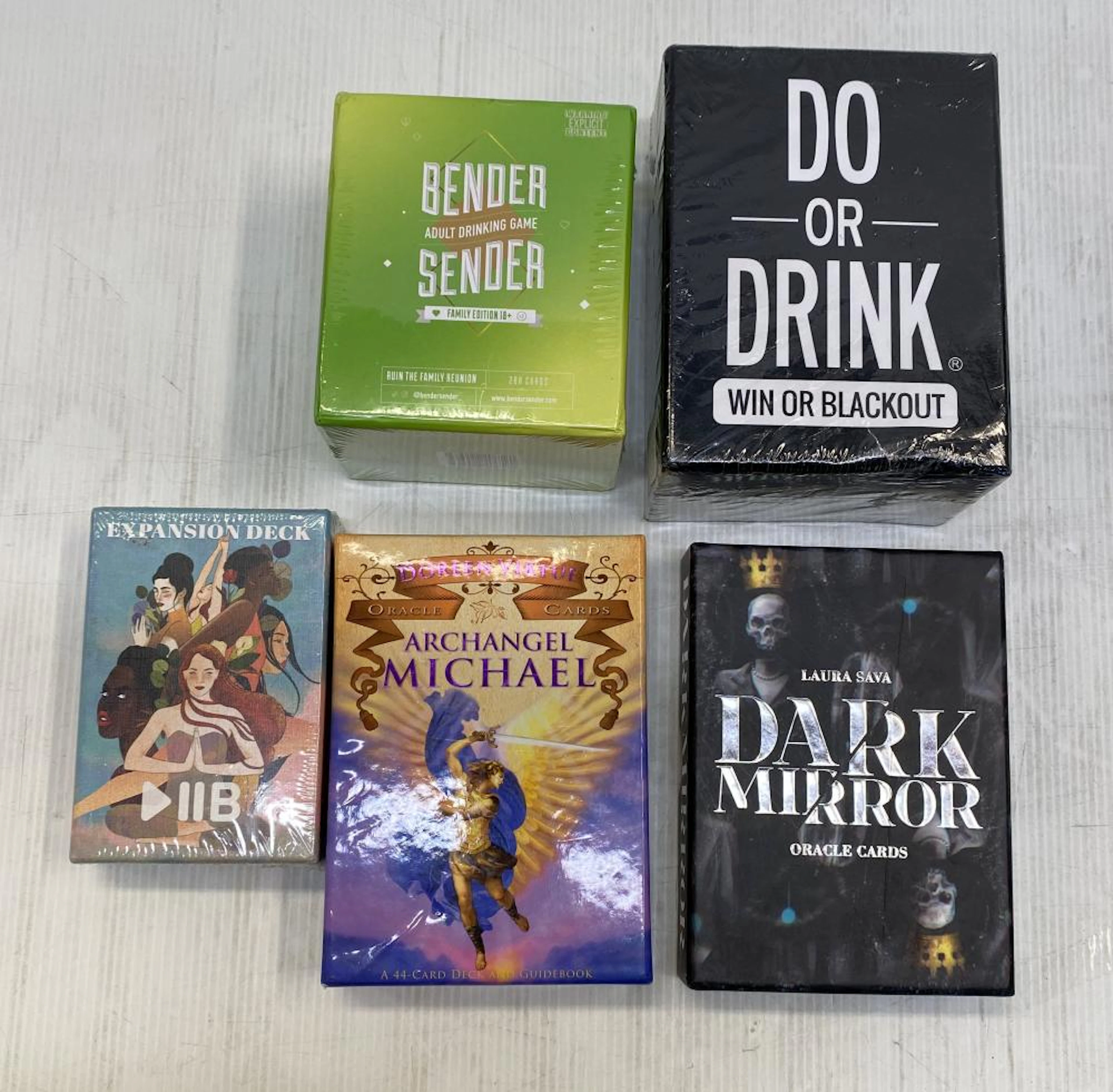 A group of card decks one marked Dark Mirror