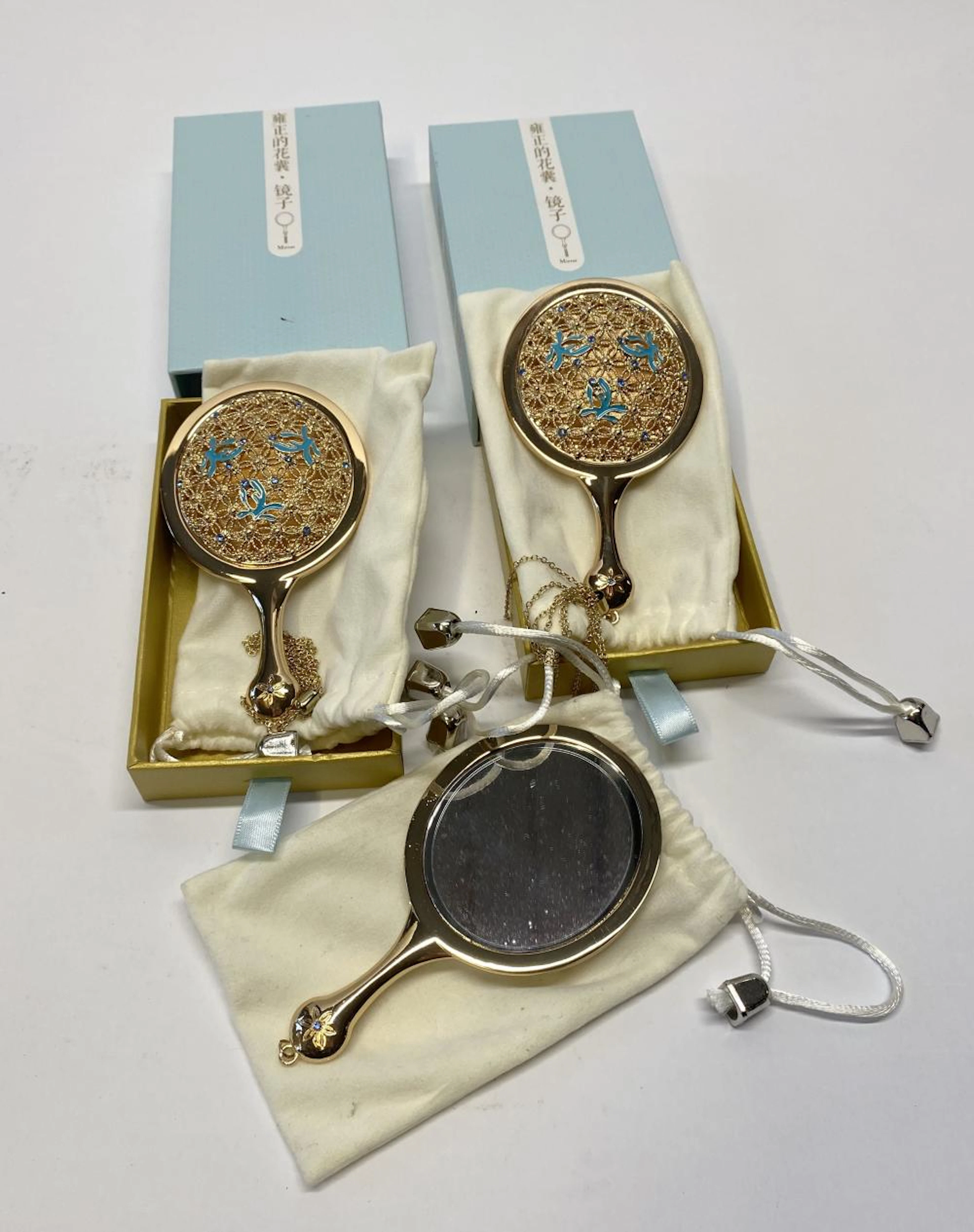 Three mini hand mirrors
