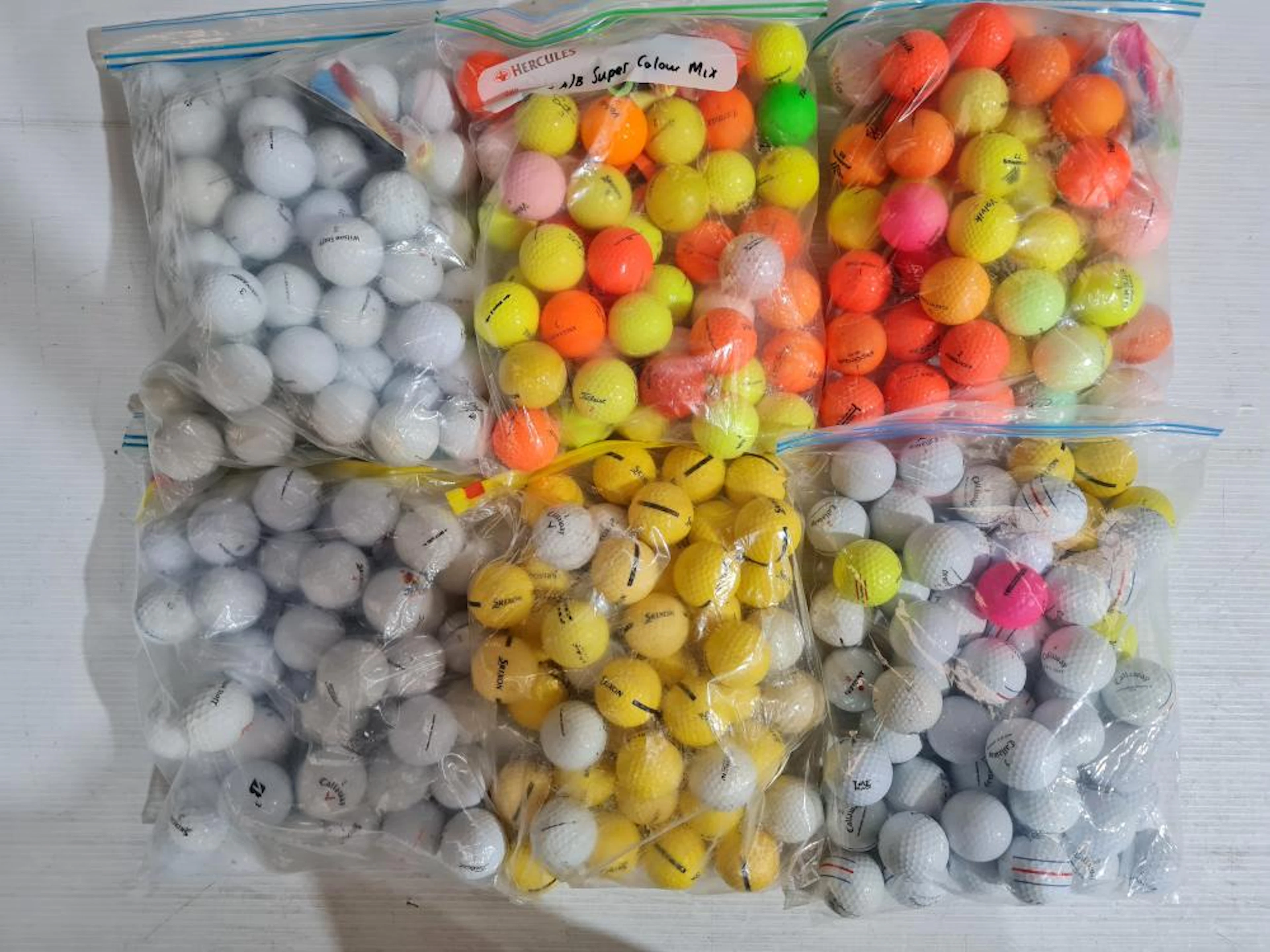 A large number of (mostly new) Golf Balls