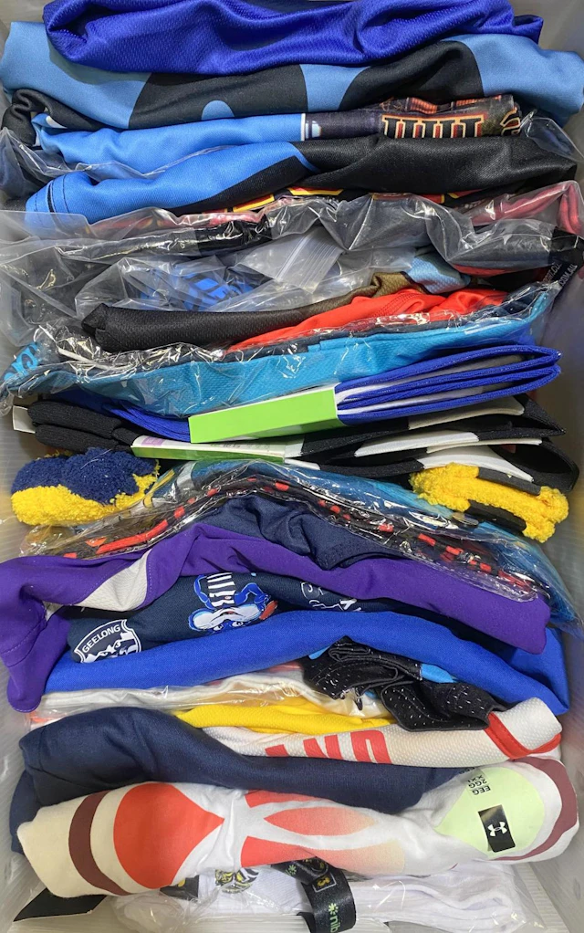 A group of various sporting uniforms various size/styles