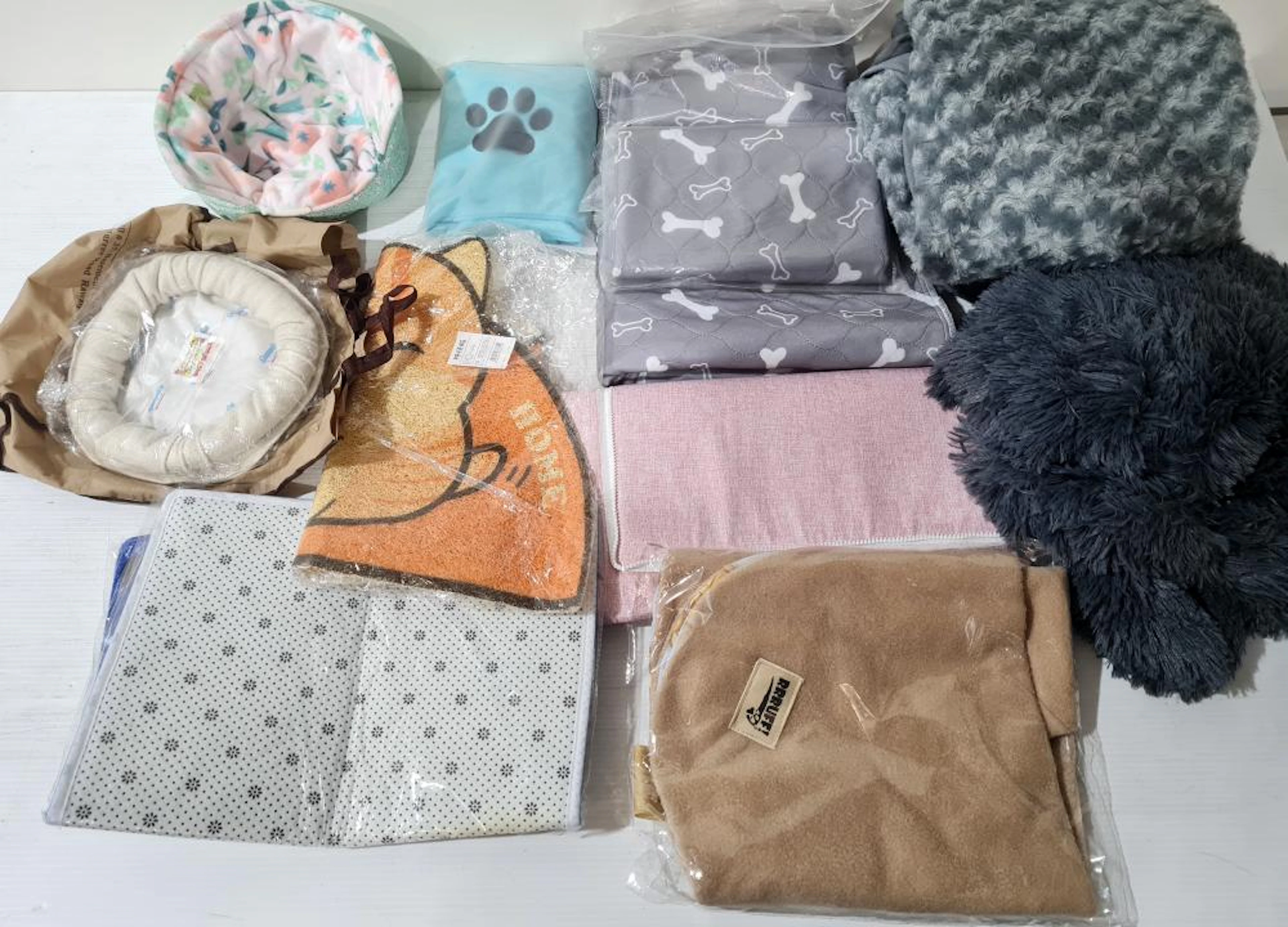 A box lot of Cat/pet rugs/beds, etc