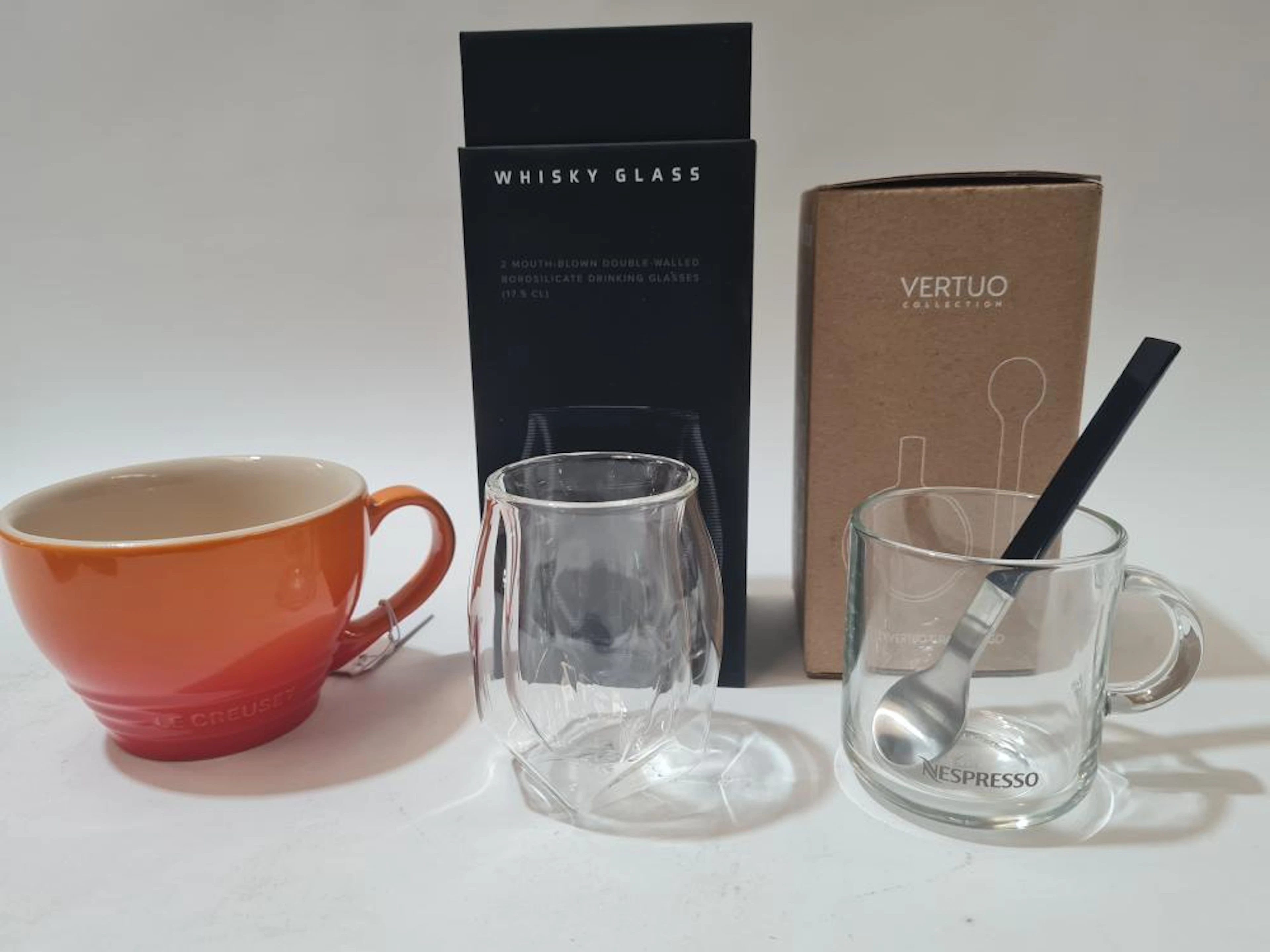 A Le Cruset mug, Two NORLN whiskey glasses + NESPRESSO glass, jug, spoons