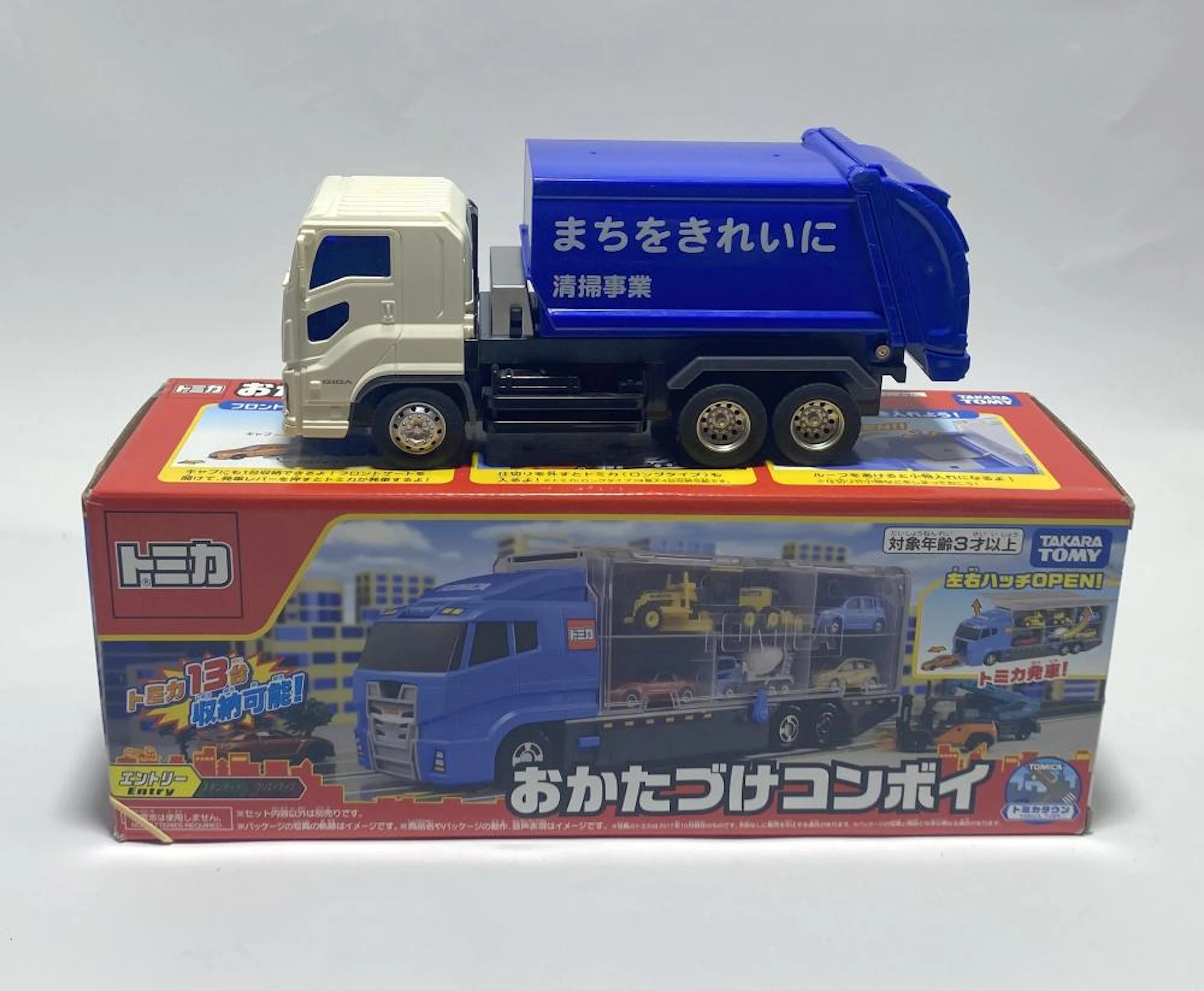 Two truck toys marked Takara Tomy etc.