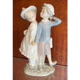A Lladro Porcelain Figure of a Boy & Girl
