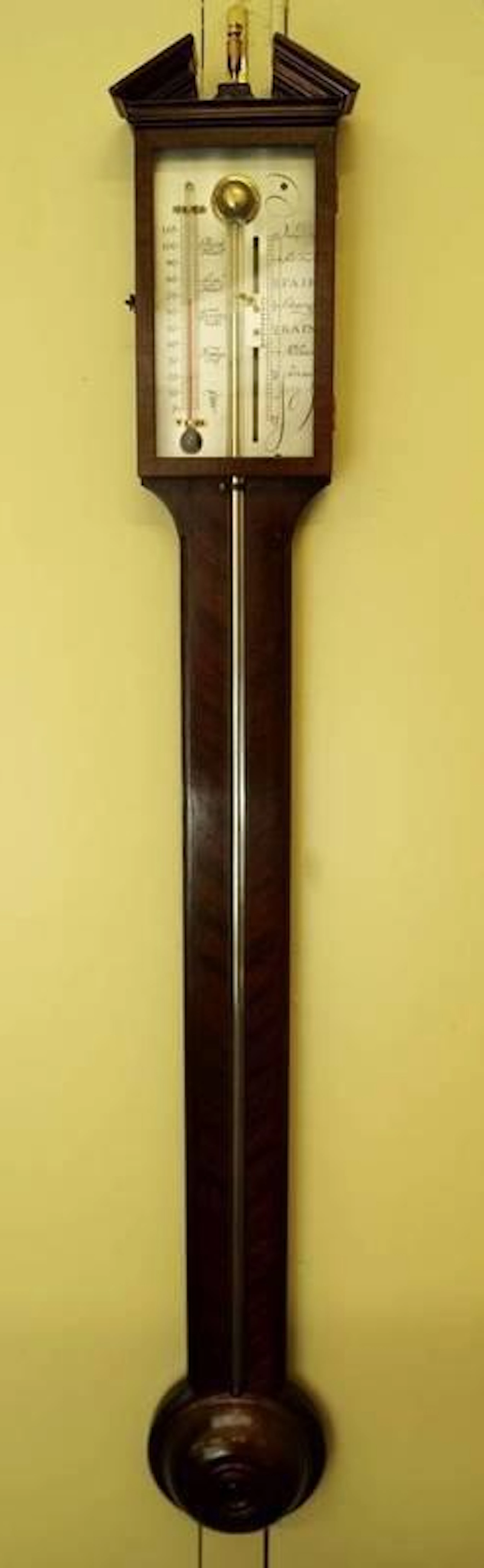 A George III style mahogany stick barometer, with architectural cresting