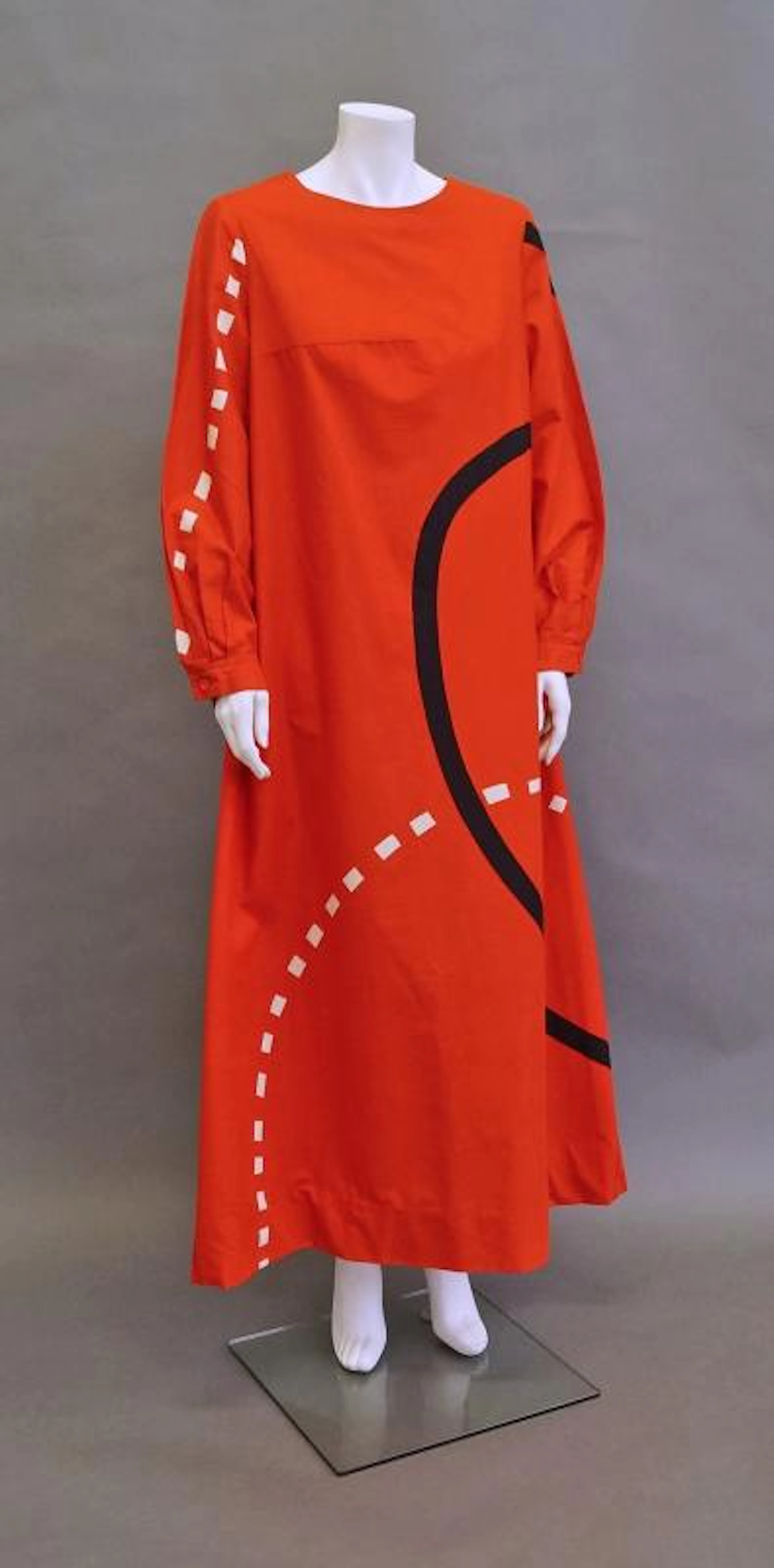 Marimekko: An orange cotton A-line maxi-dress, with abstract black