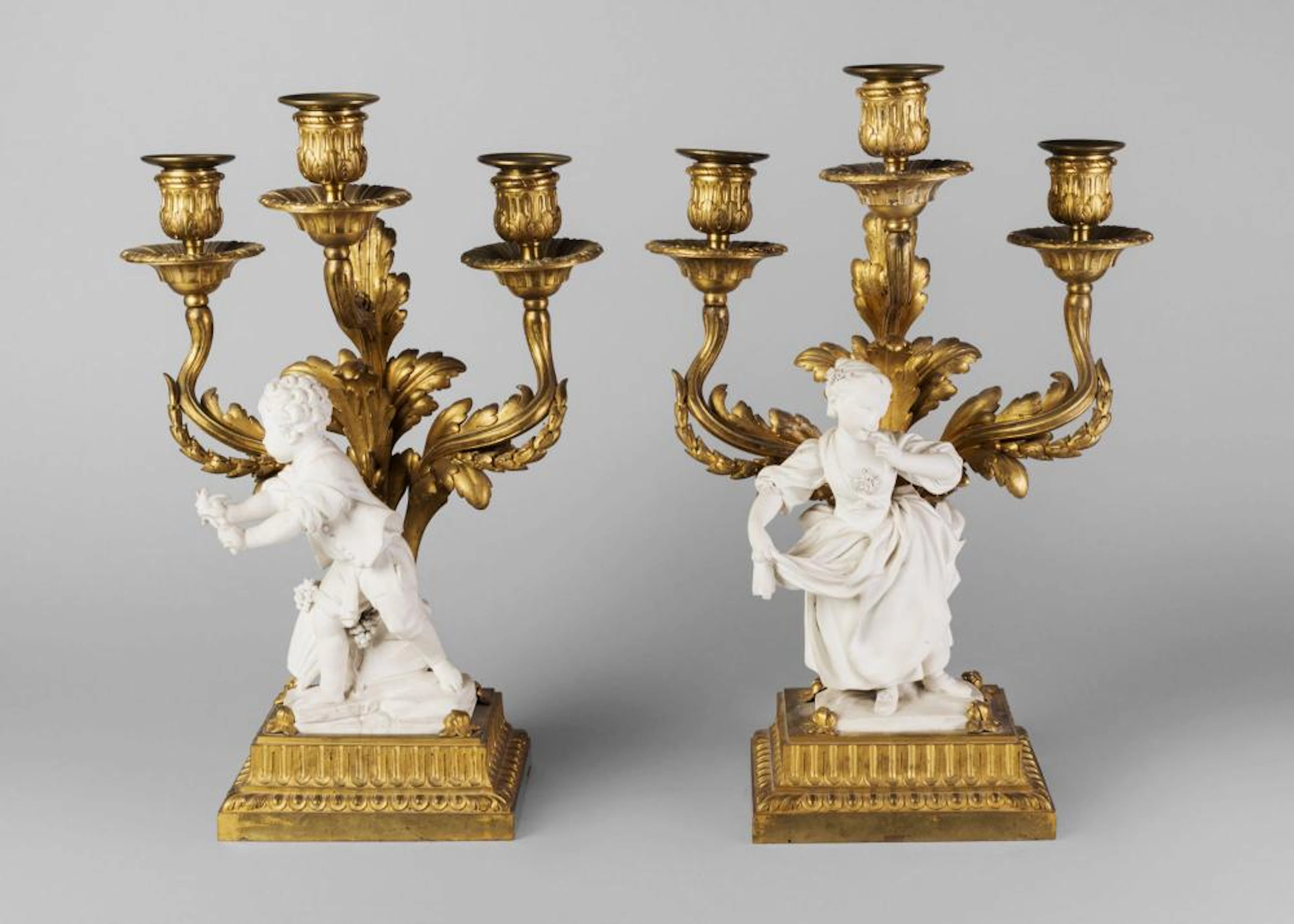 A pair of Louis XVI three light ormolu candelabra, the bases of rectangular