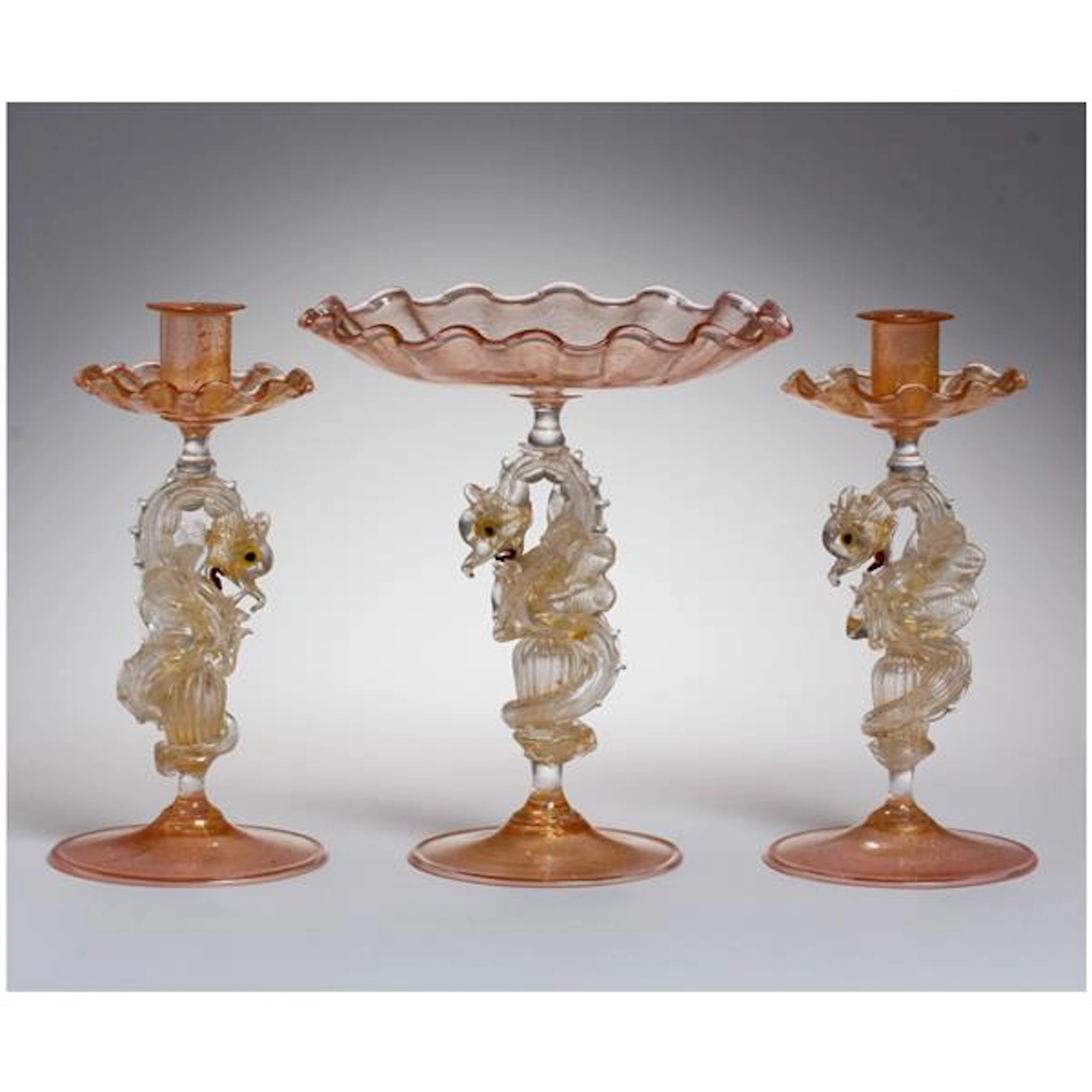 Salviati zoomorphic dragon art glass tazza and a pair of candlesticks