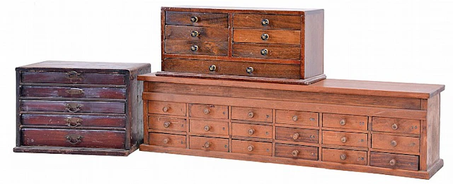 Three watchmakers parts cabinets with contents