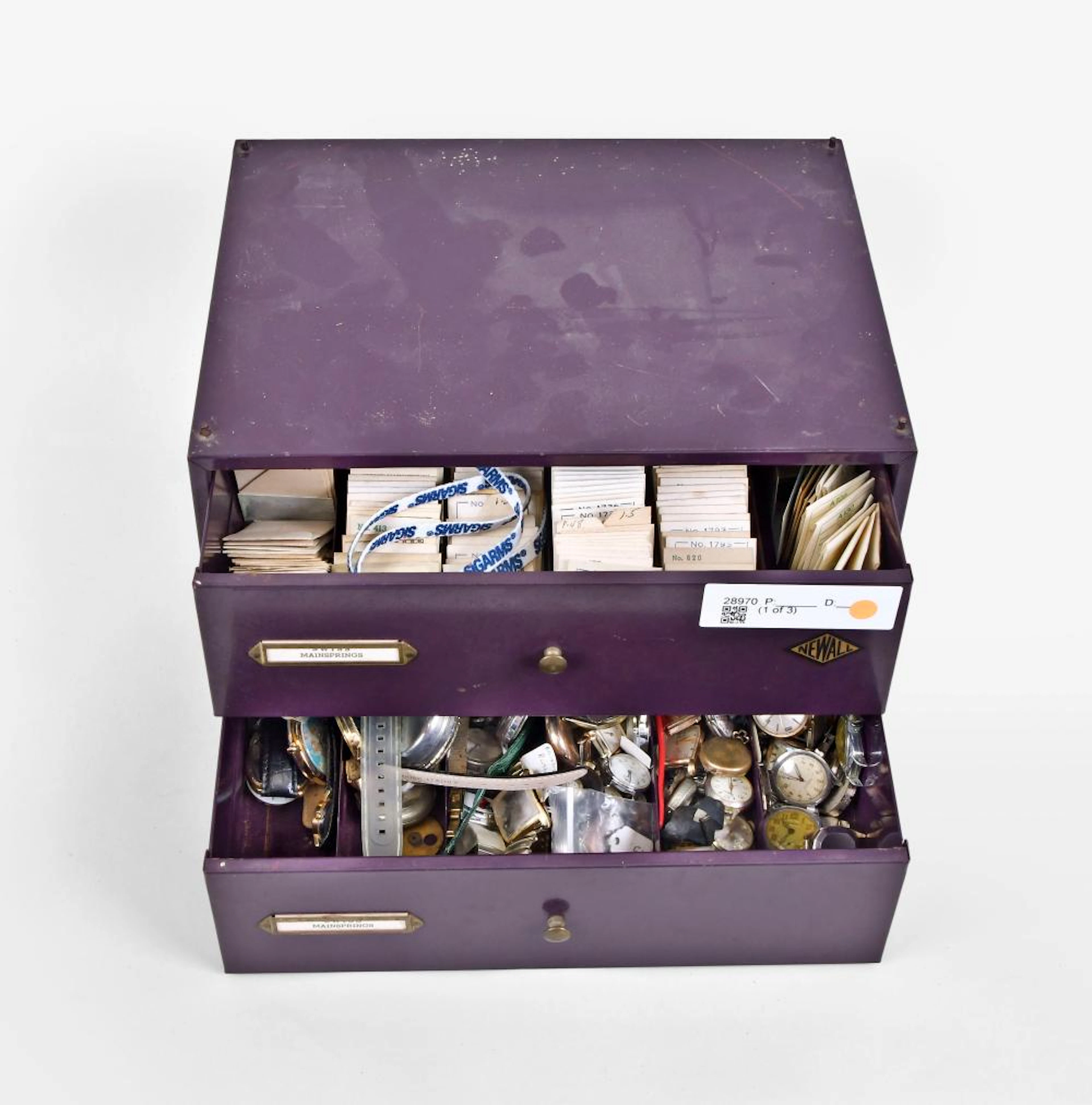 A lot of cabinets containing watch mainsprings and wrist watches and movements