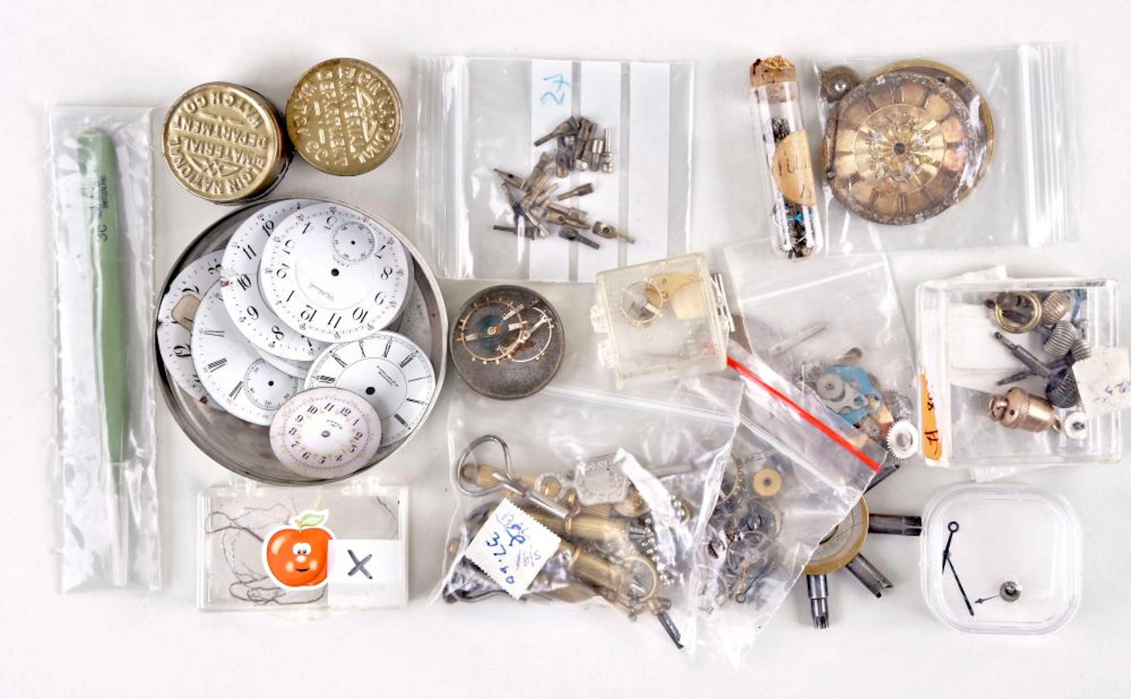 A small lot of pocket watch parts related material and keys