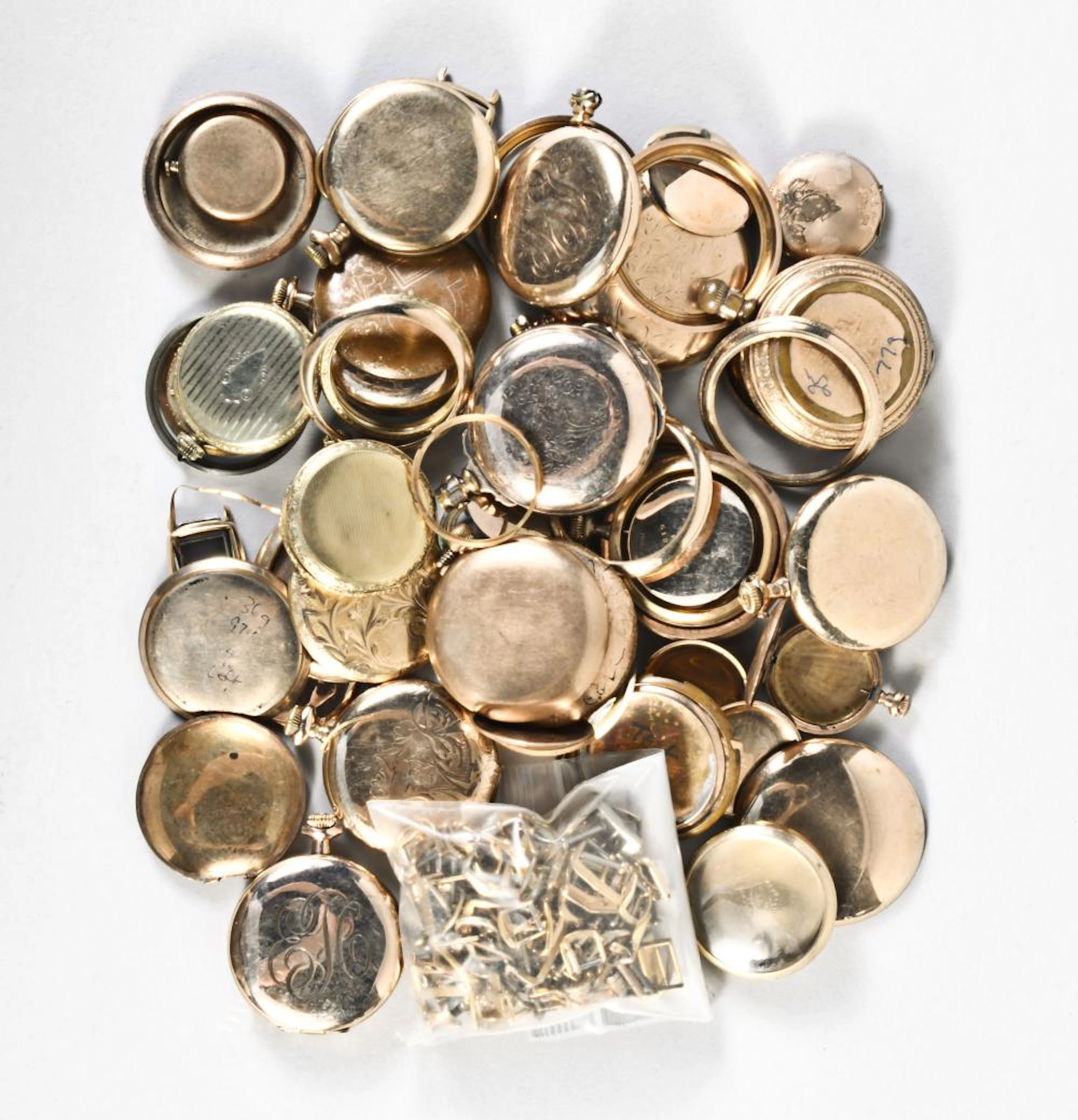 A large lot of gold filled pocket watch cases and wrist watch strap buckles