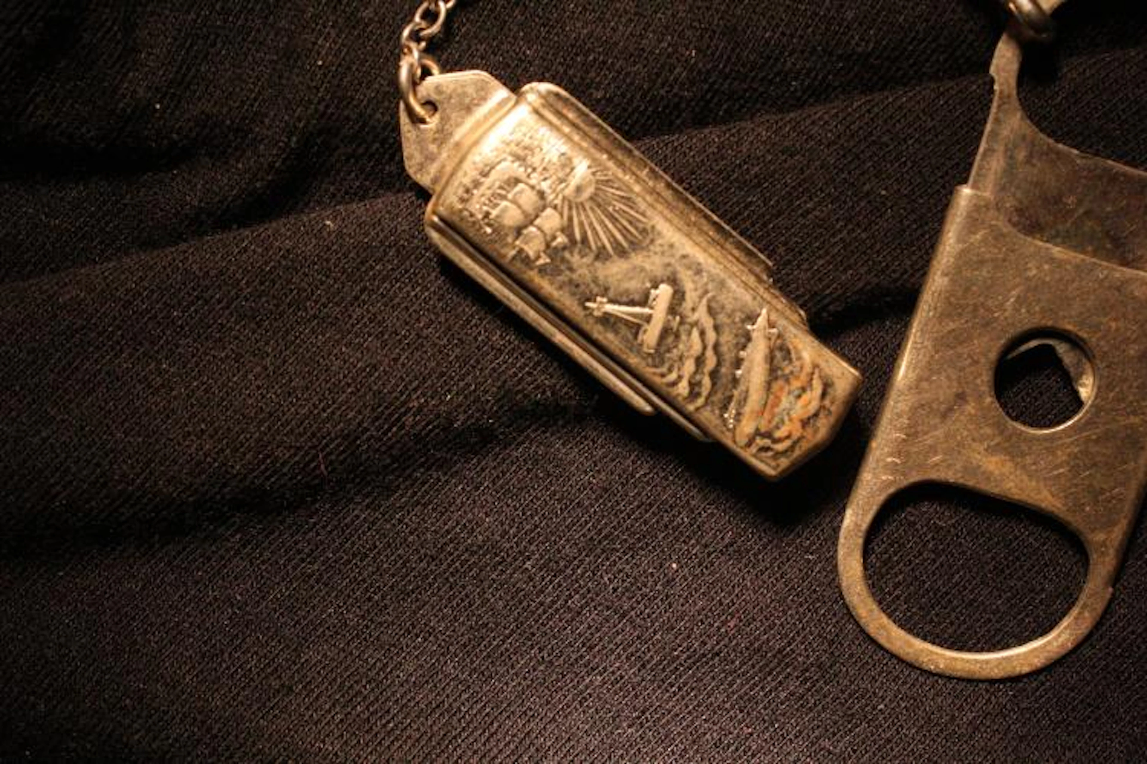 Watch FOB cigar cutter, motif of zeppelin, bi-plane and ship circa 1910