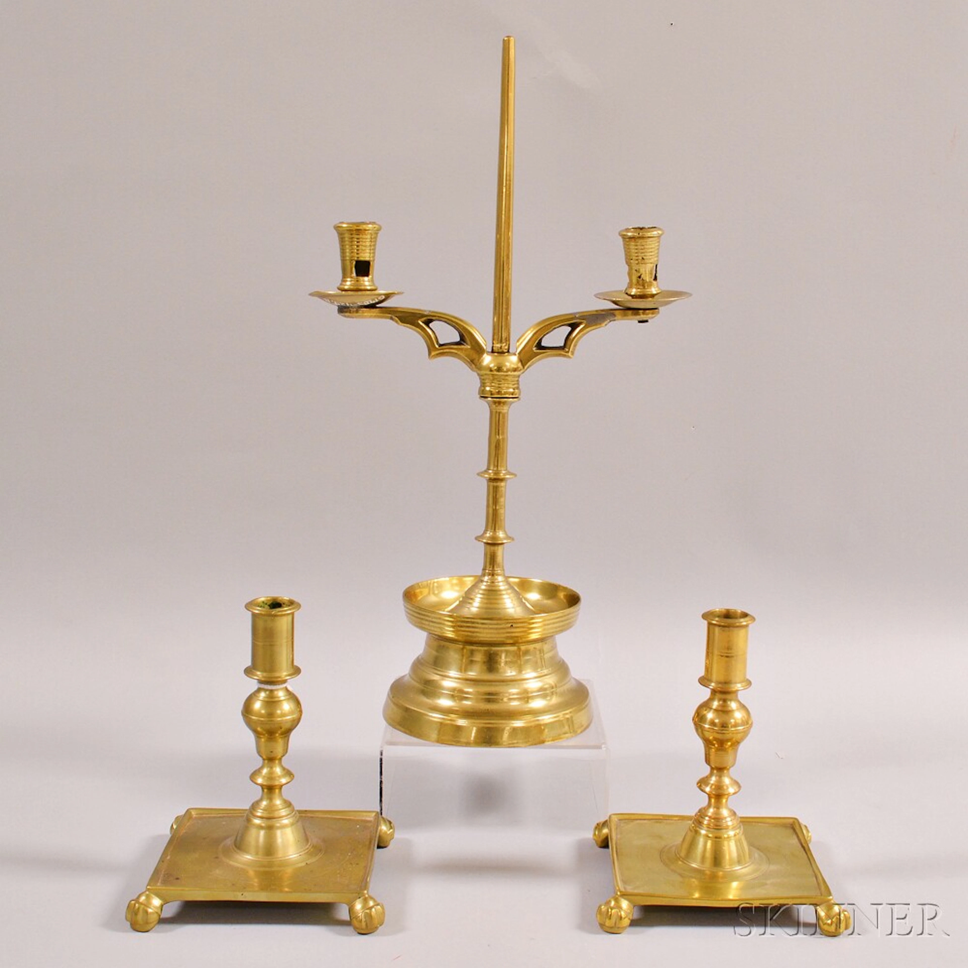 Near Pair of Brass Candlesticks and a Brass Two-light Candelabra