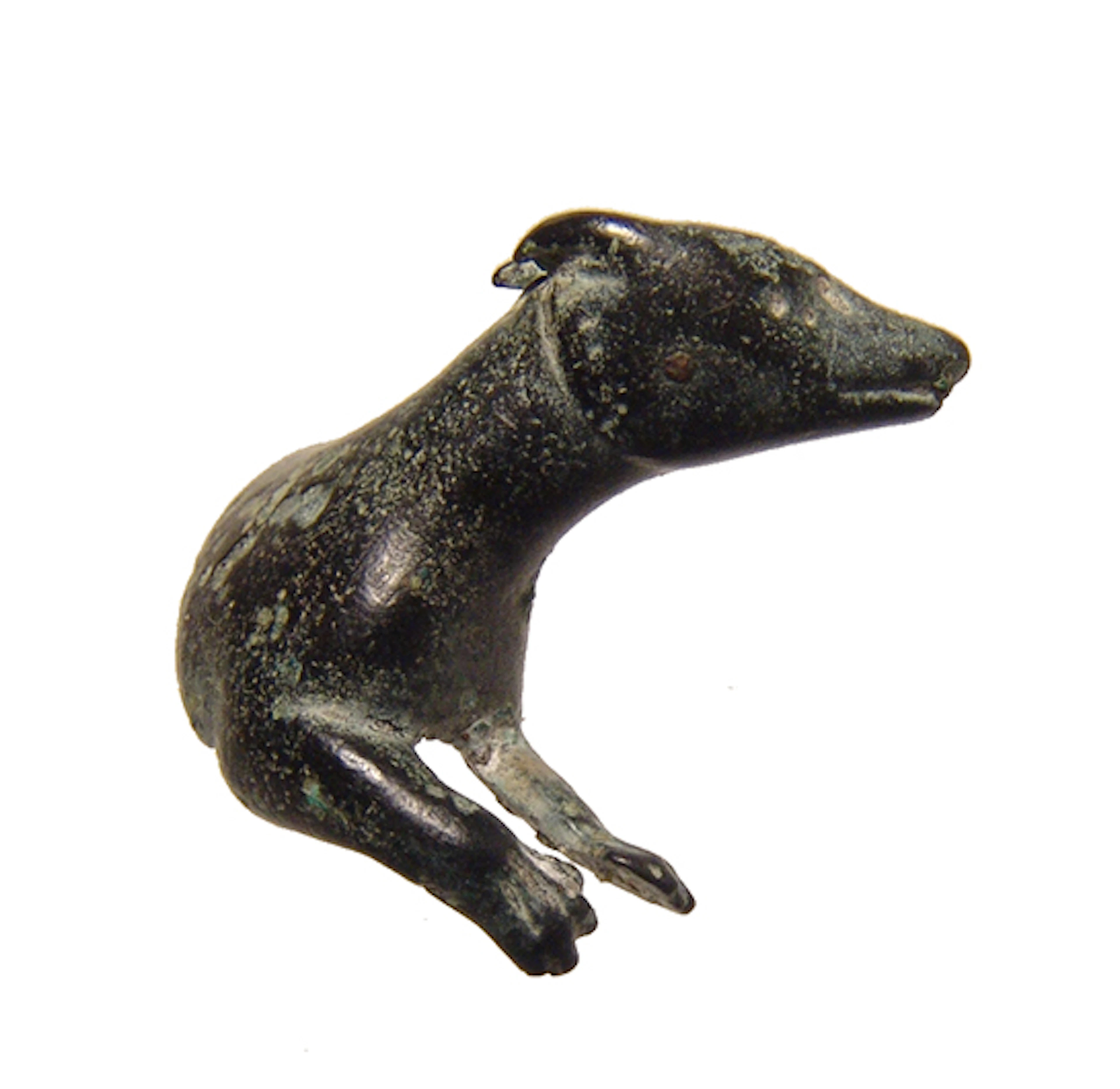 A Roman bronze figurine of a reclining dog