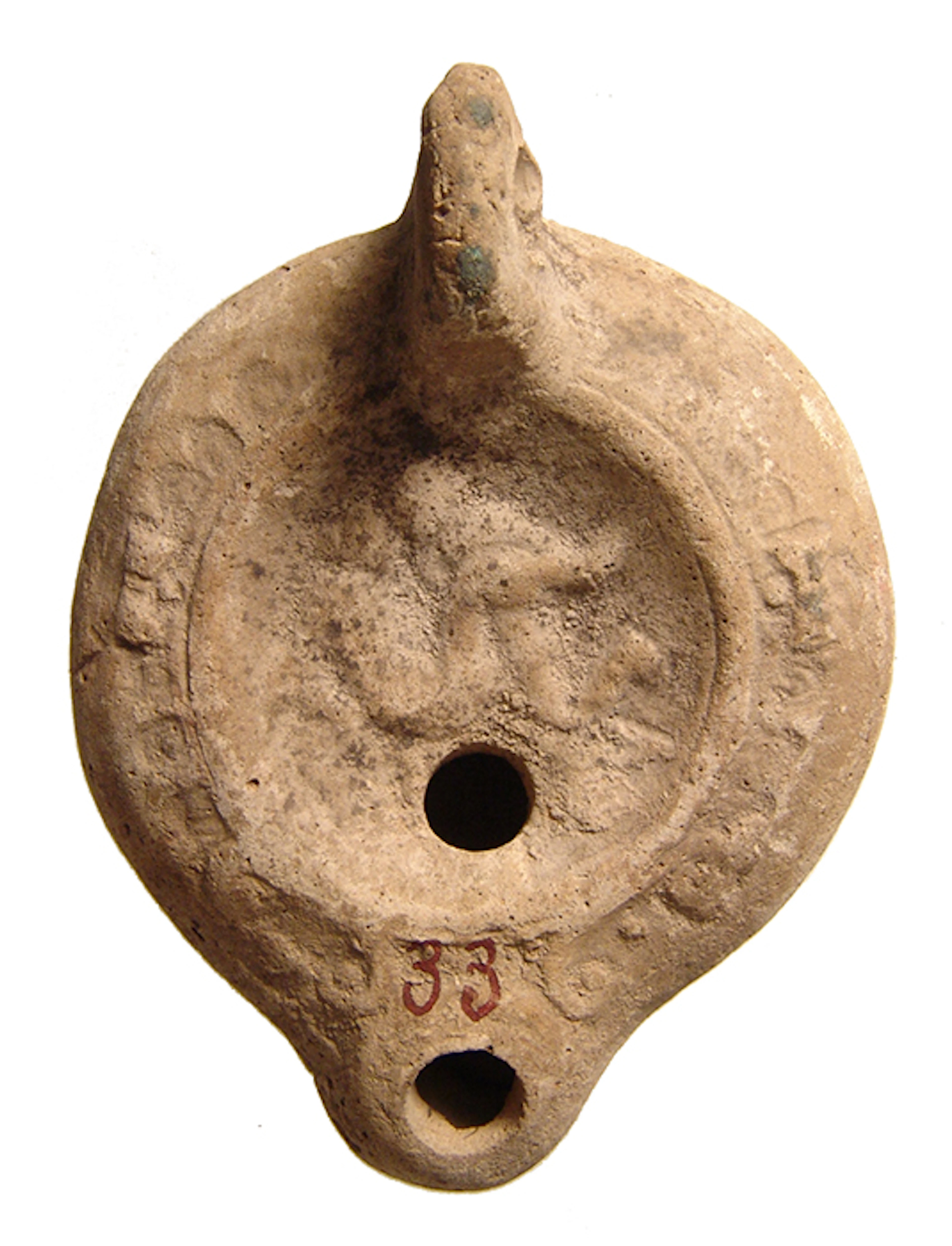 An erotic Roman oil lamp depicting a male and female