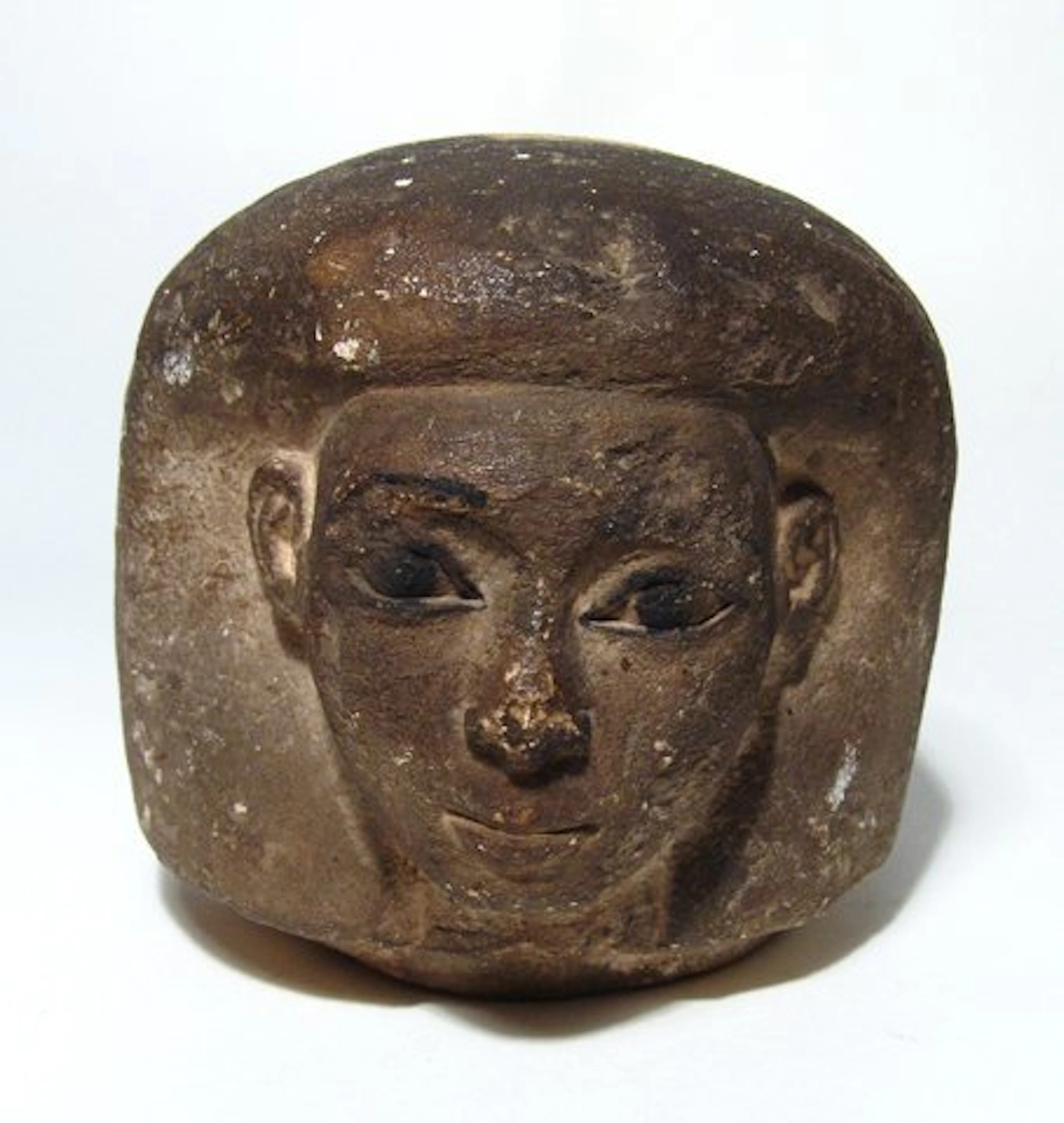 An Egyptian limestone canopic jar head of Imsety