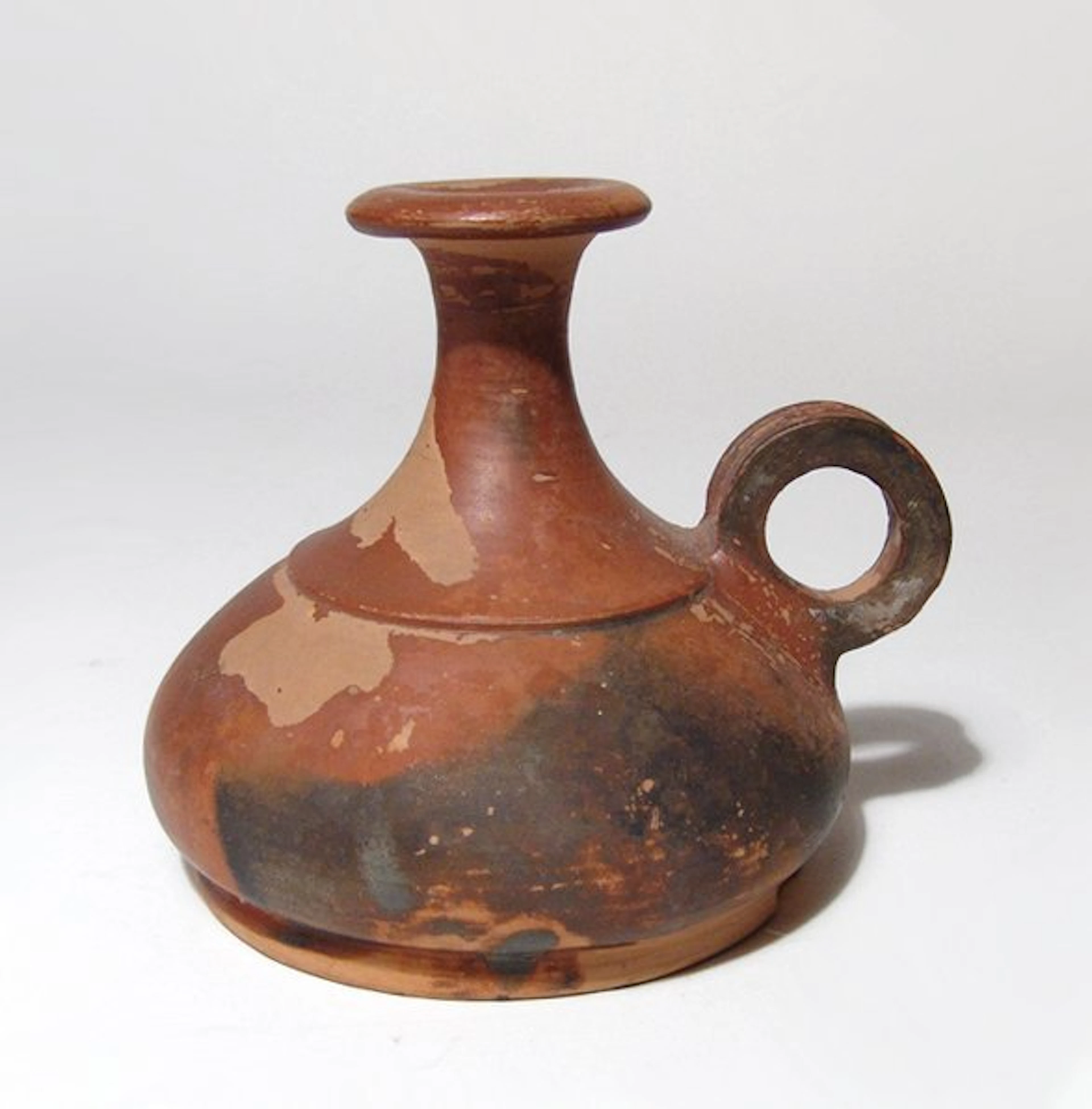 A Greek orange-slipped squat aryballos