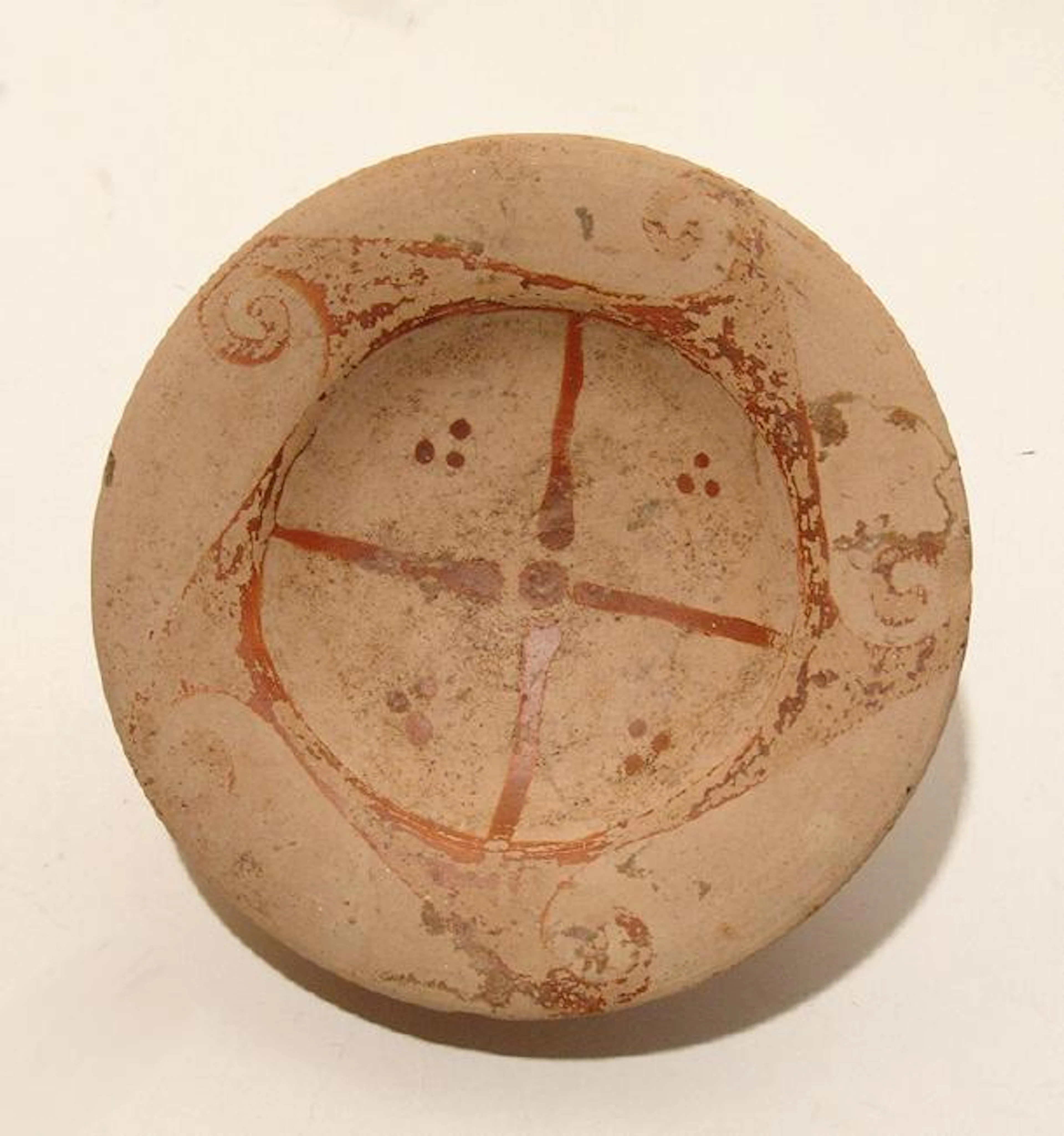 An Etruscan Genucilia group footed dish in rare red slip