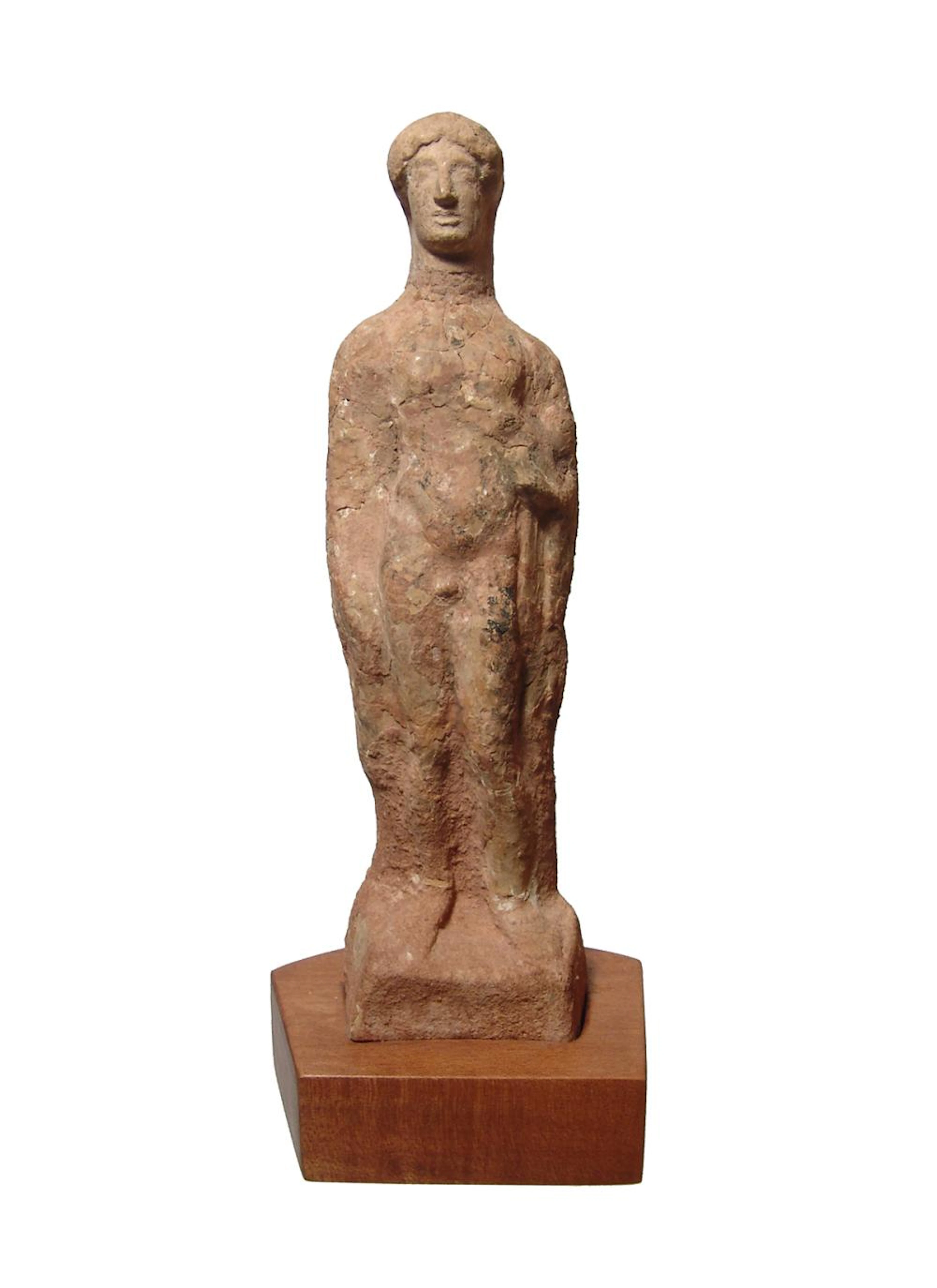 A tall Greek terracotta figure of a youth