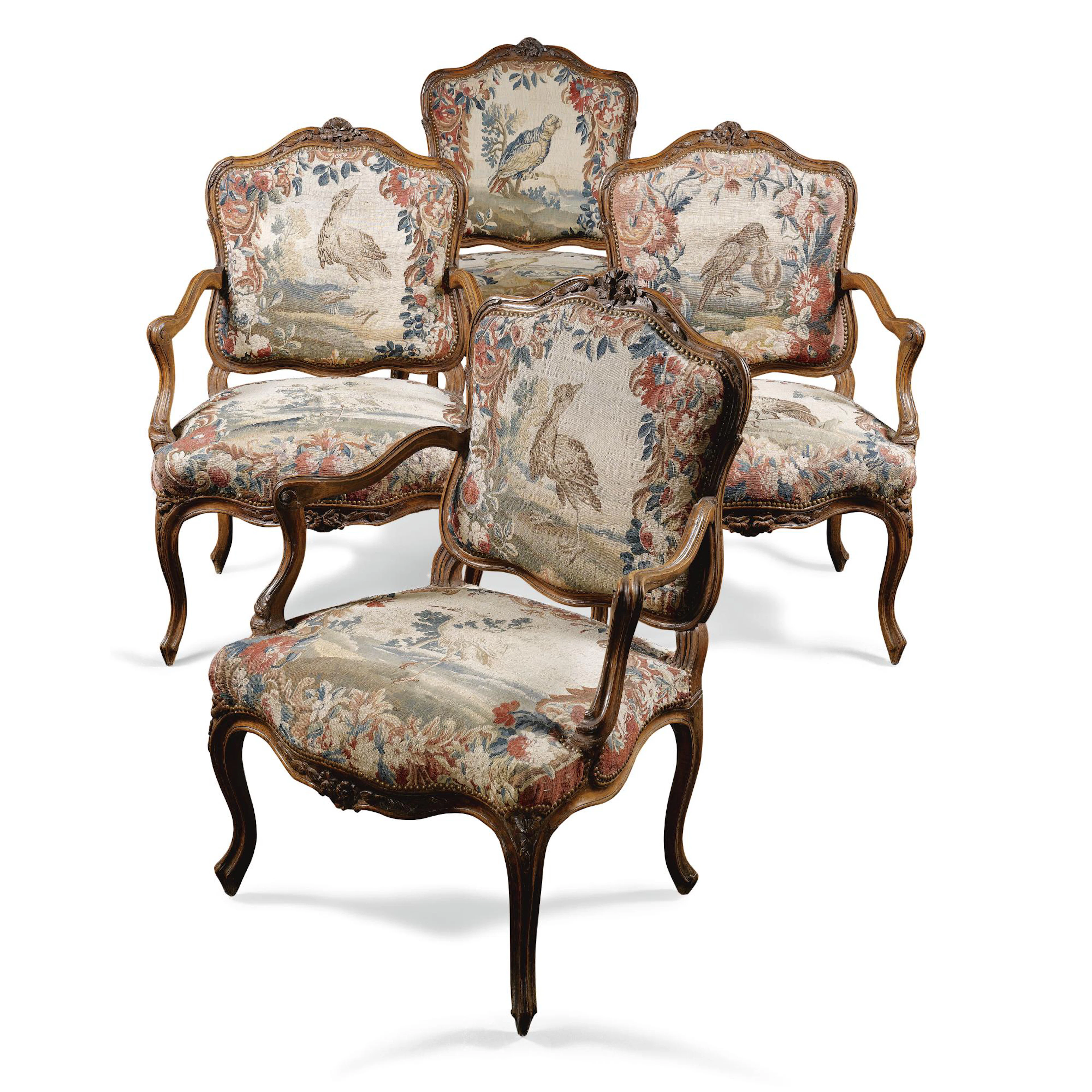 A set of four Aubusson tapestry upholstered carved walnut fauteuils, attributed to Pierre Nogaret