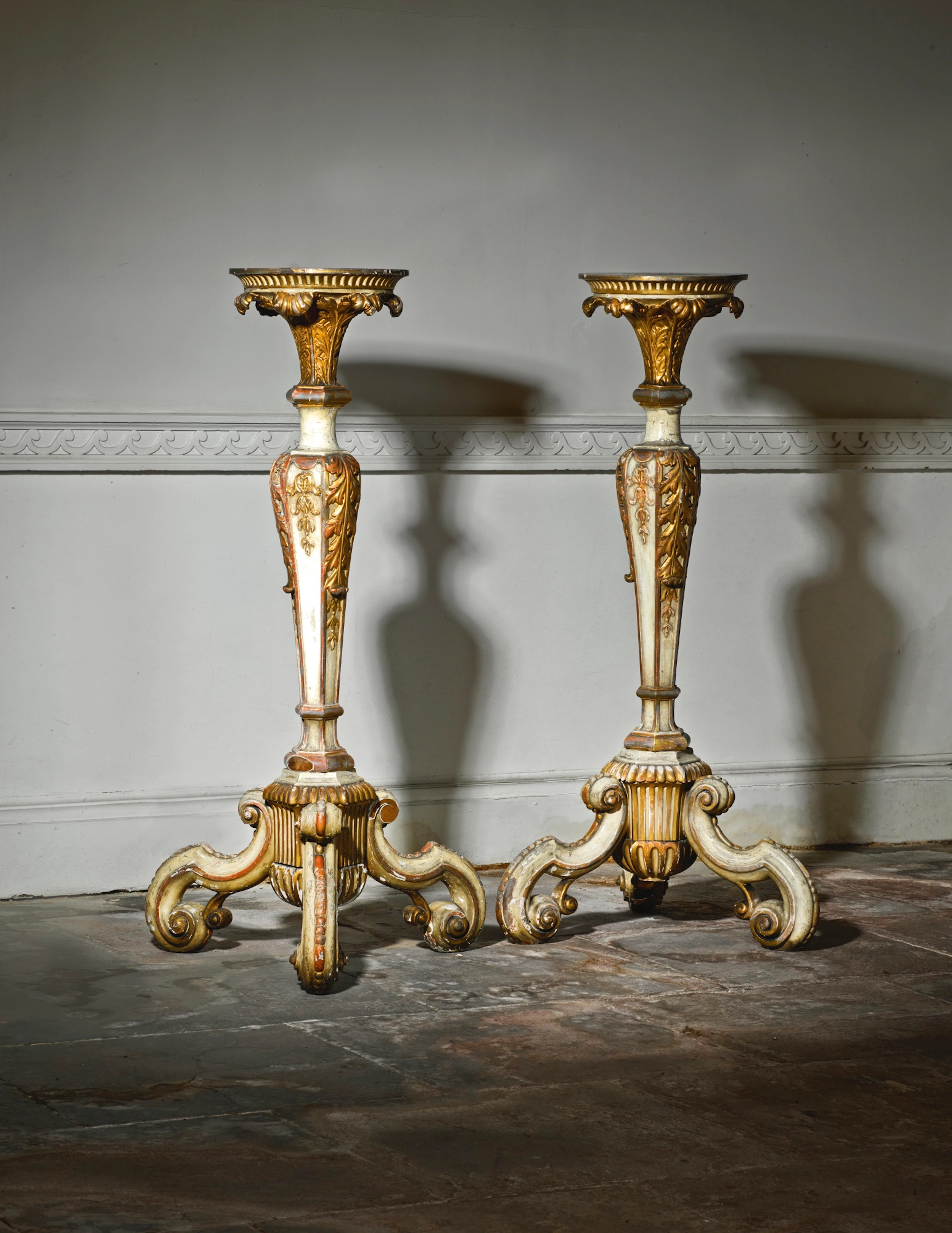 A pair of george i cream painted and parcel-gilt torchères circa 1720