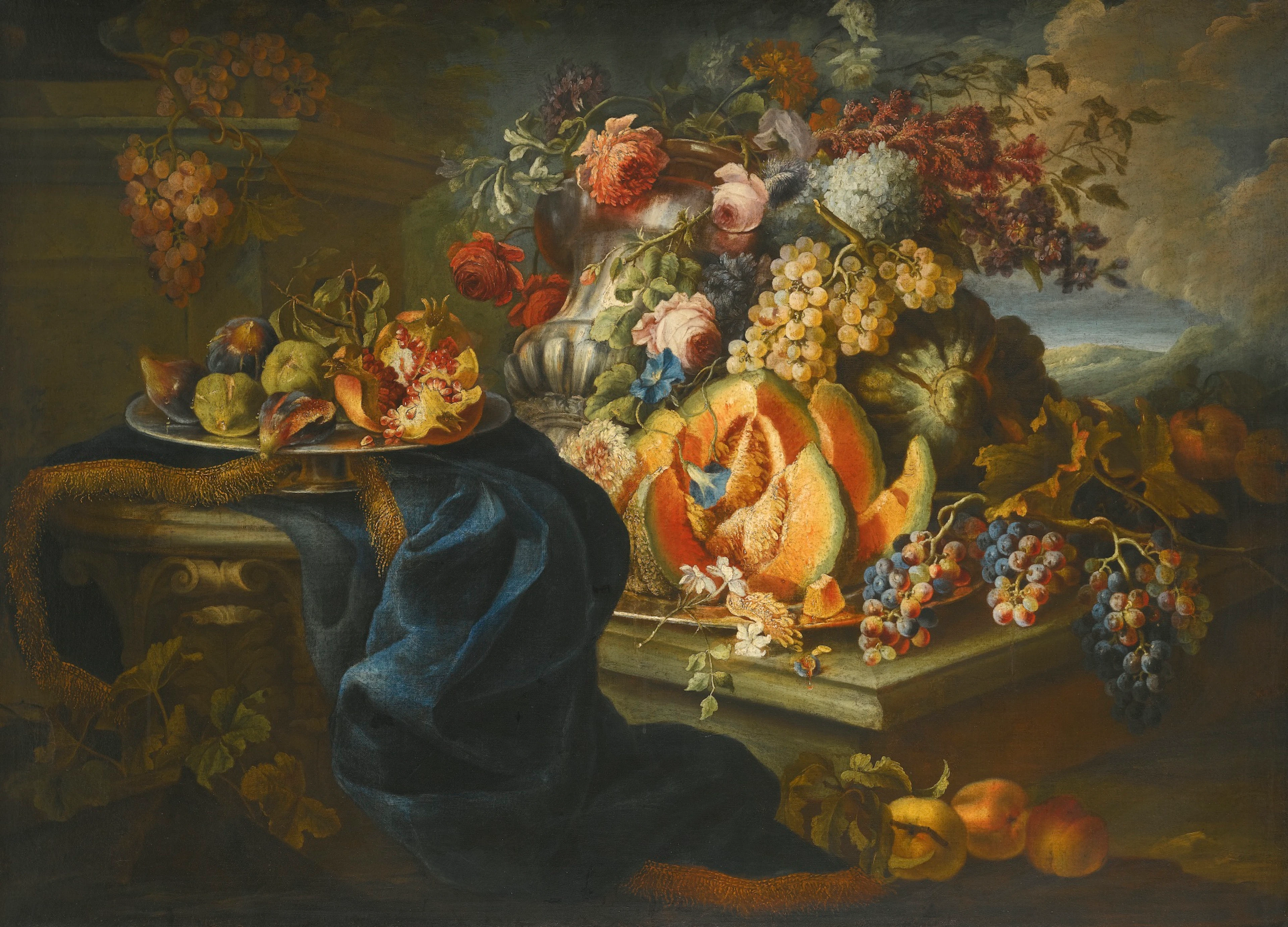 An elaborate still life of fruit and flowers piled high in an outdoor setting
