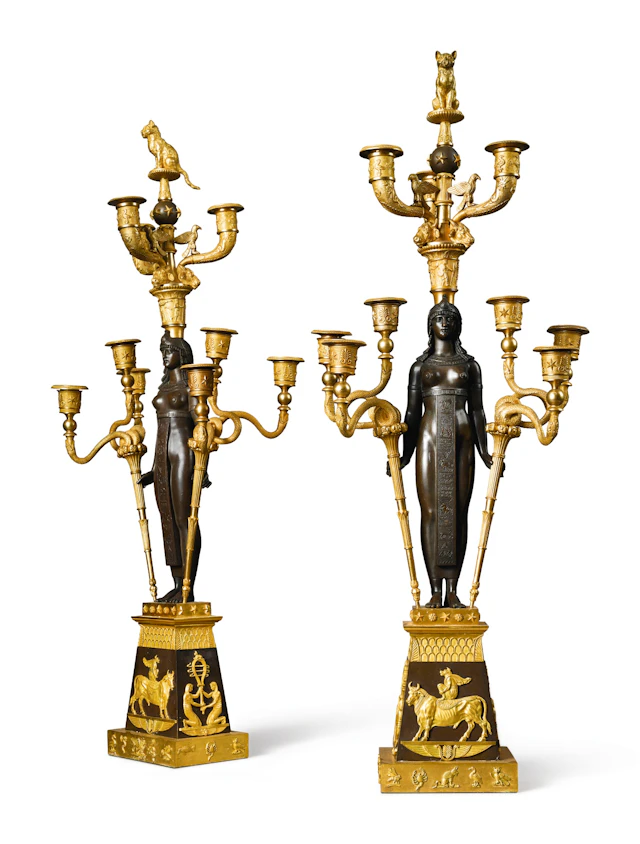 A pair of empire style patinated bronze and ormolu nine-light candelabra