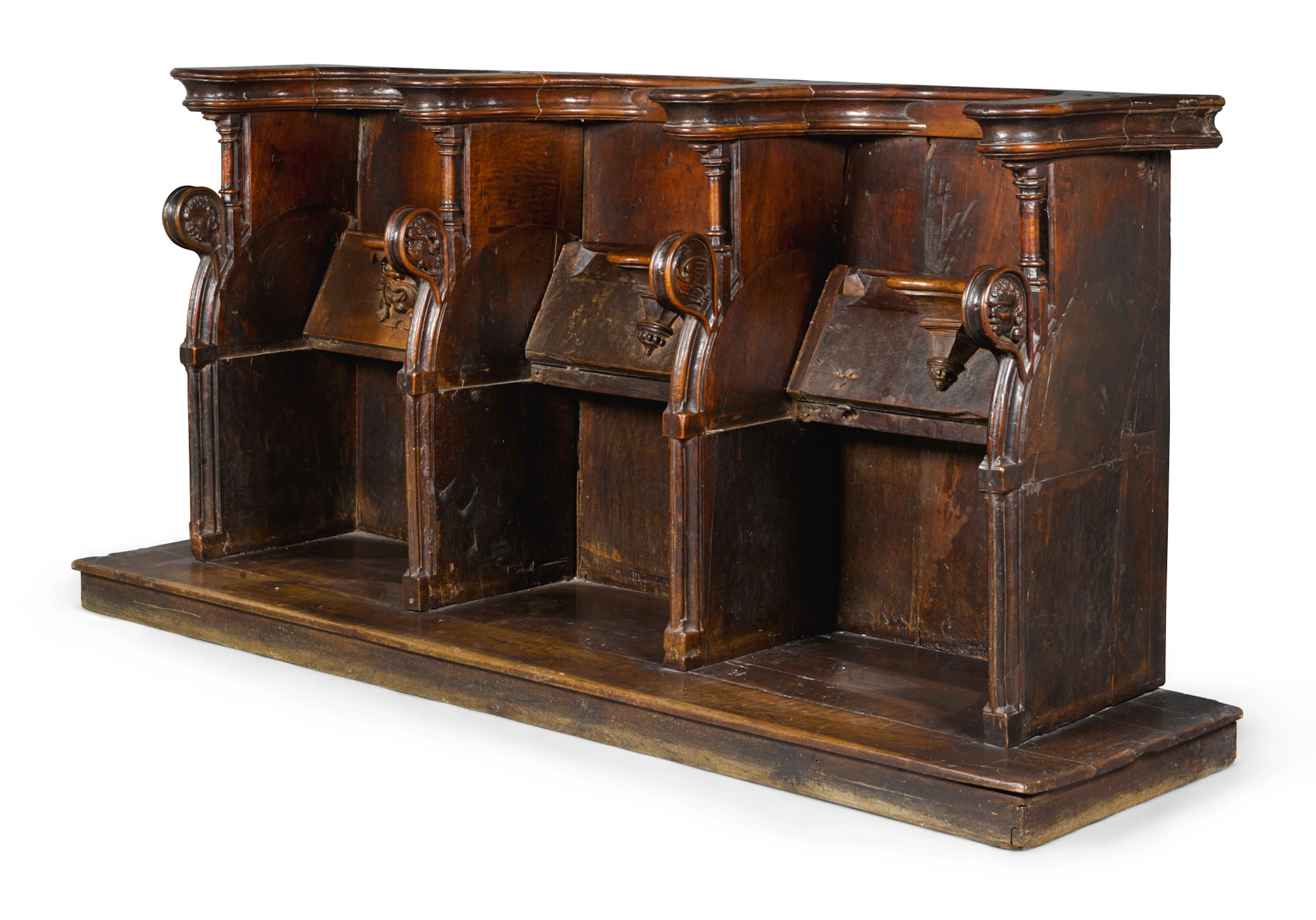 A north italian carved walnut choir bench, 16th century and later