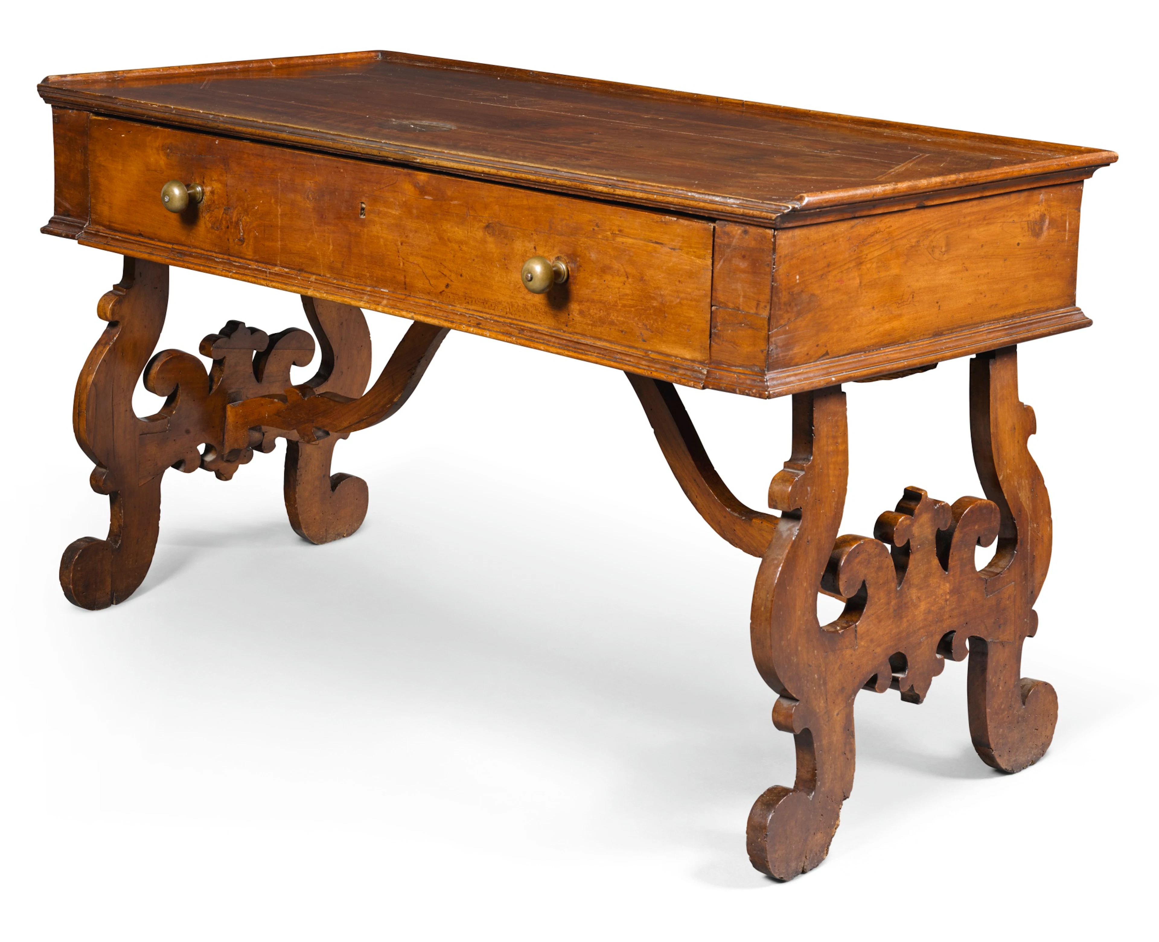 An italian walnut writing table, probably piedmont, 17th century and later