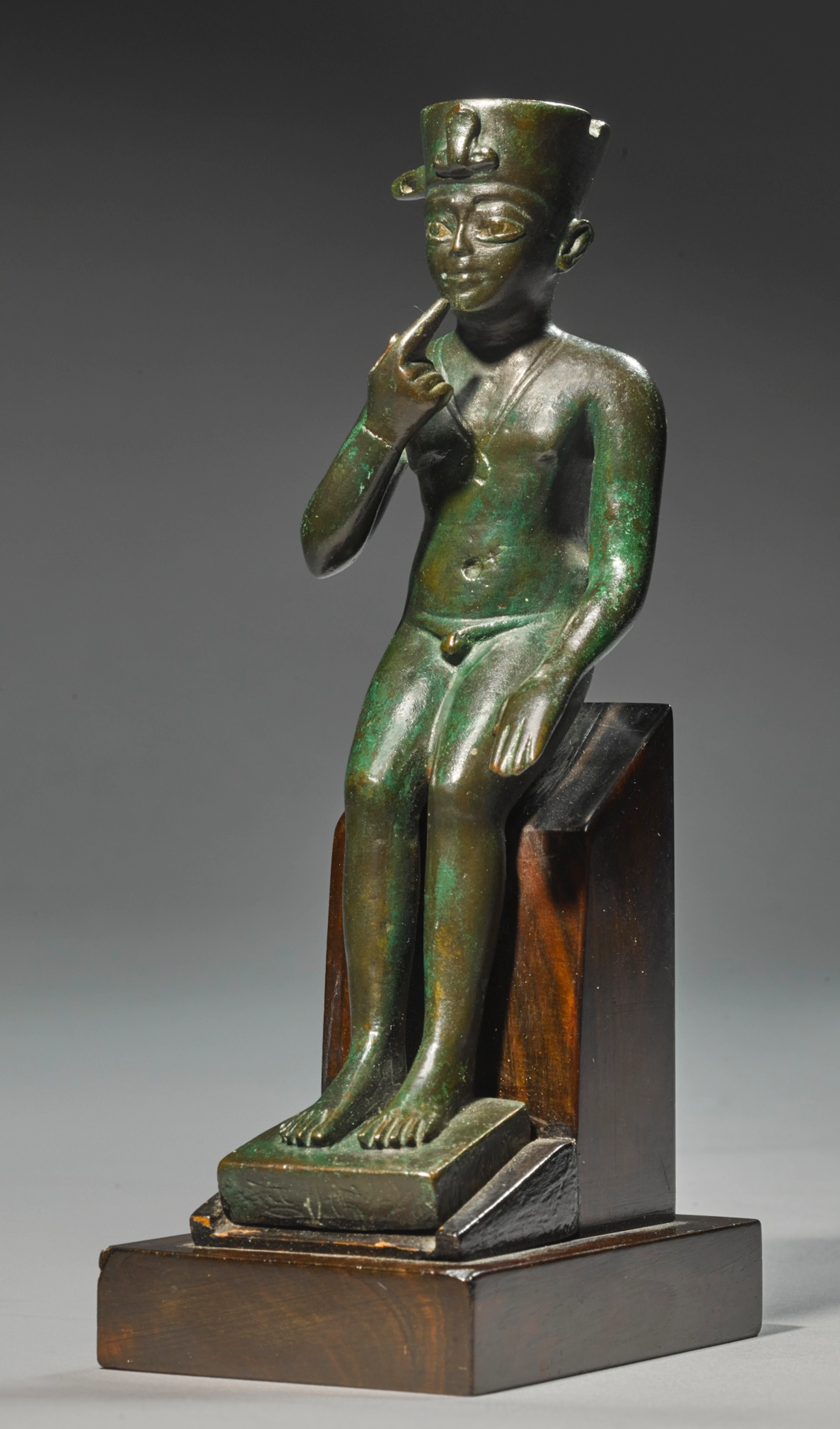 AN EGYPTIAN BRONZE FIGURE OF HARPOCRATES, LATE PERIOD, 716-30 B.C.
