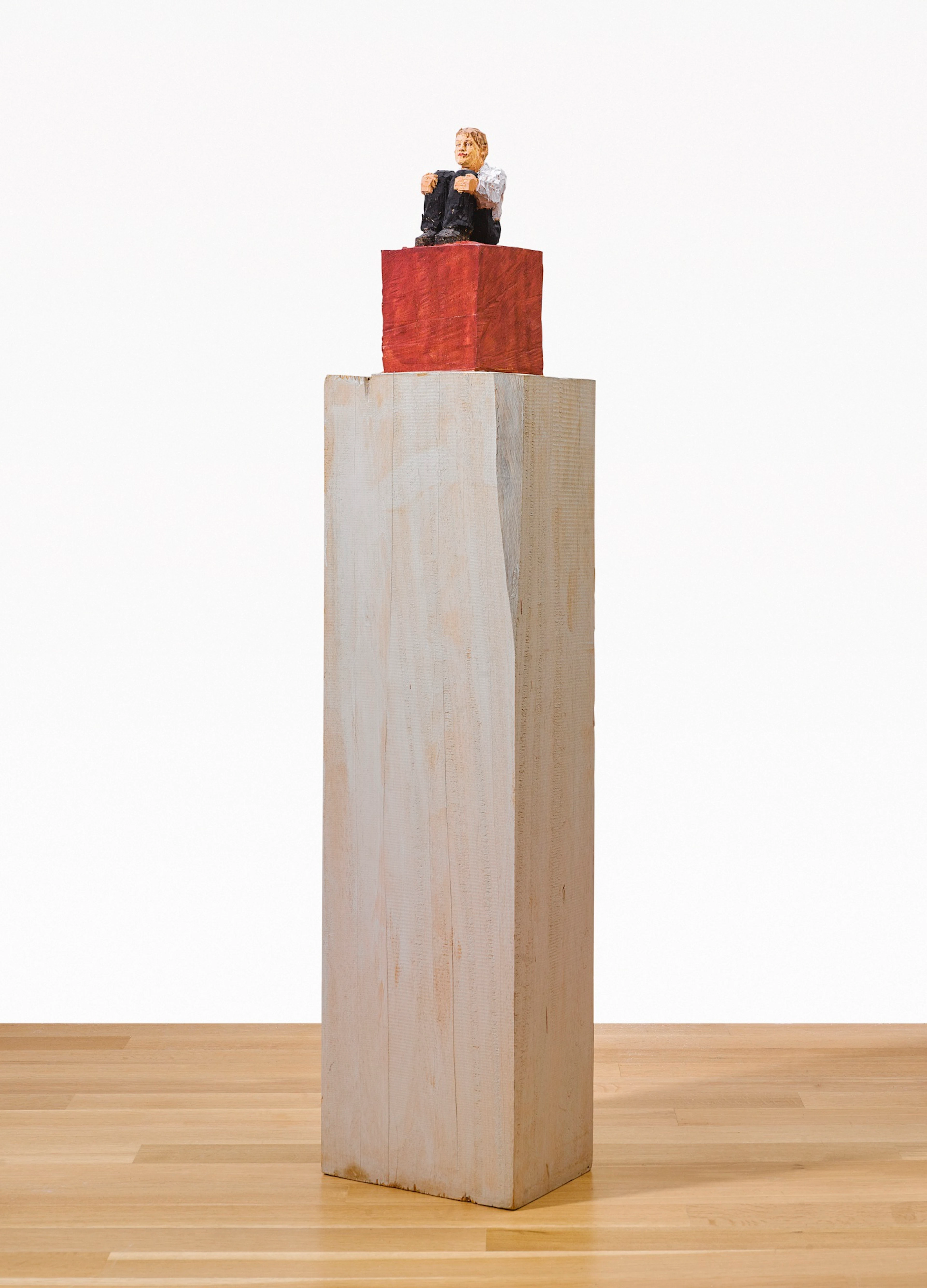 Small Man Sitting on Cube