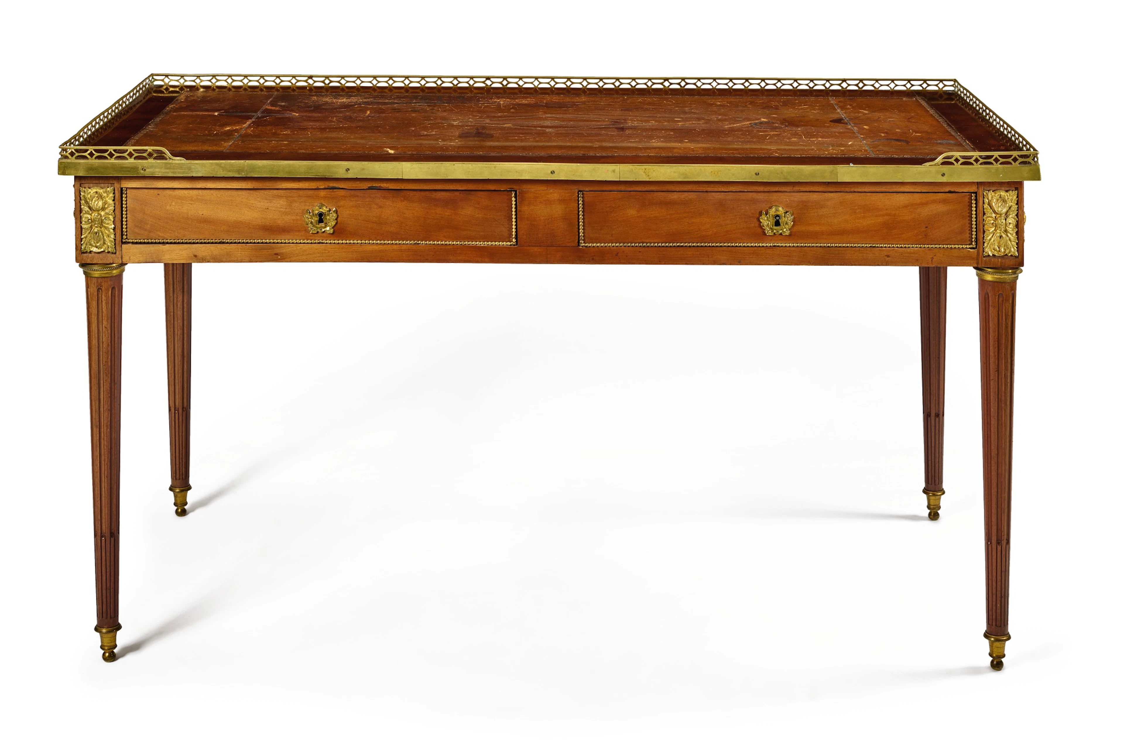 A louis xvi gilt bronze-mounted mahogany bureau plat by f.j