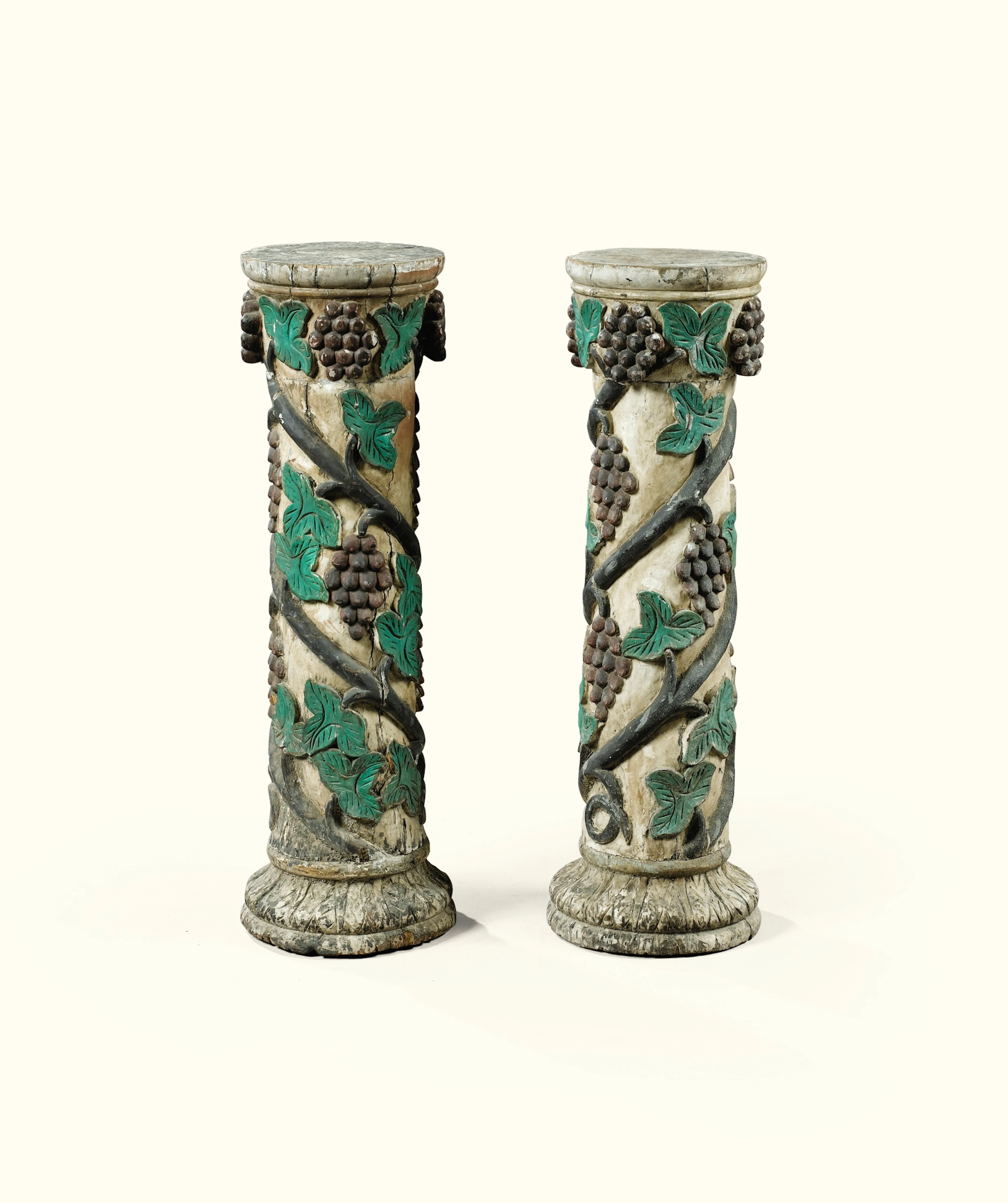 A PAIR OF ITALIAN CARVED AND POLYCHROMED WOOD COLUMNS WITH VINES
