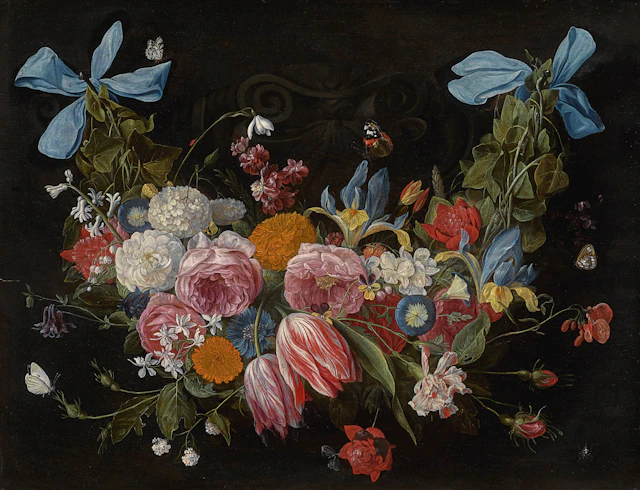 A swag of flowers fixed with two blue ribbons