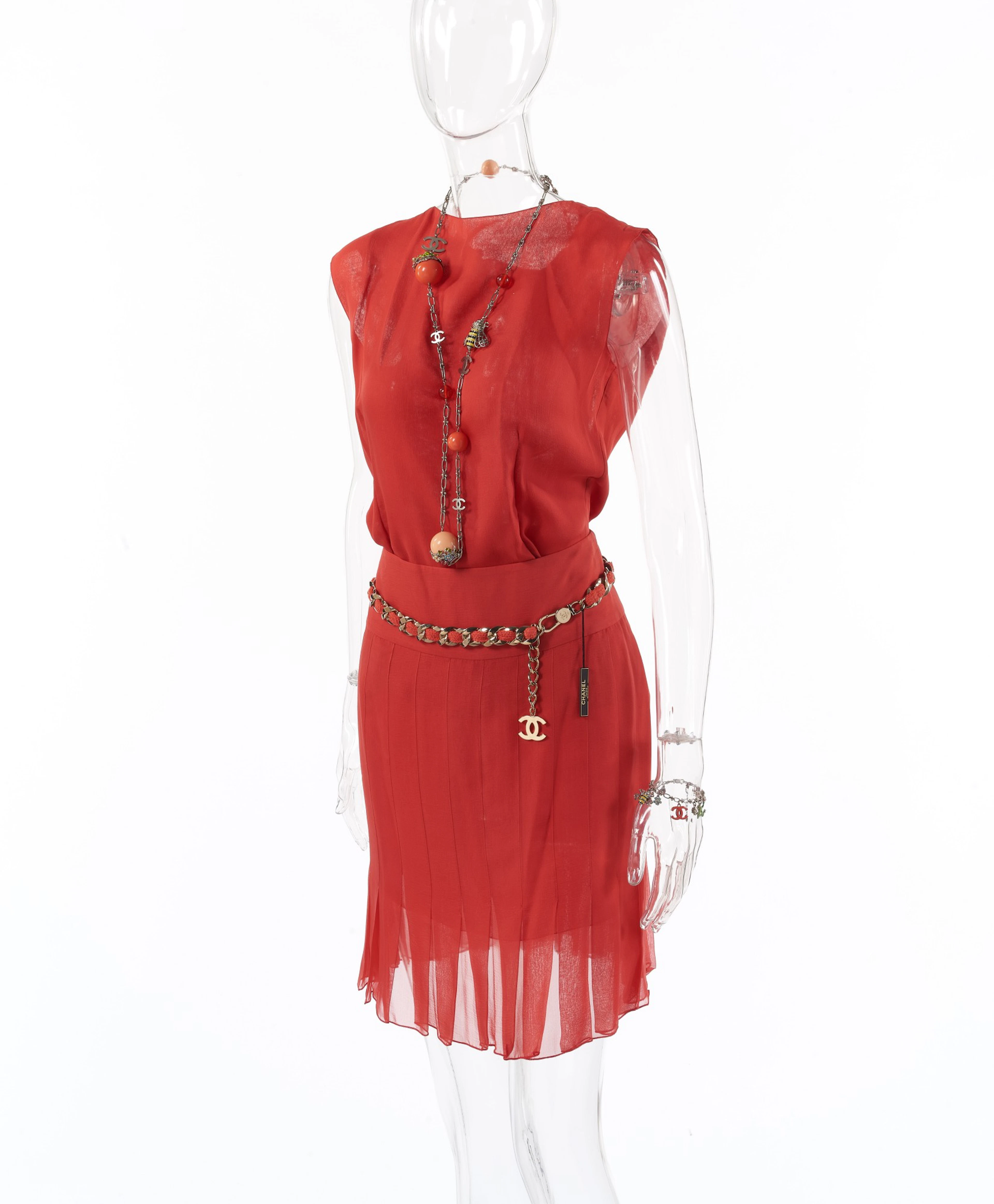 Chanel | coral silk ensemble, charm necklace and bracelet and classic chain belt