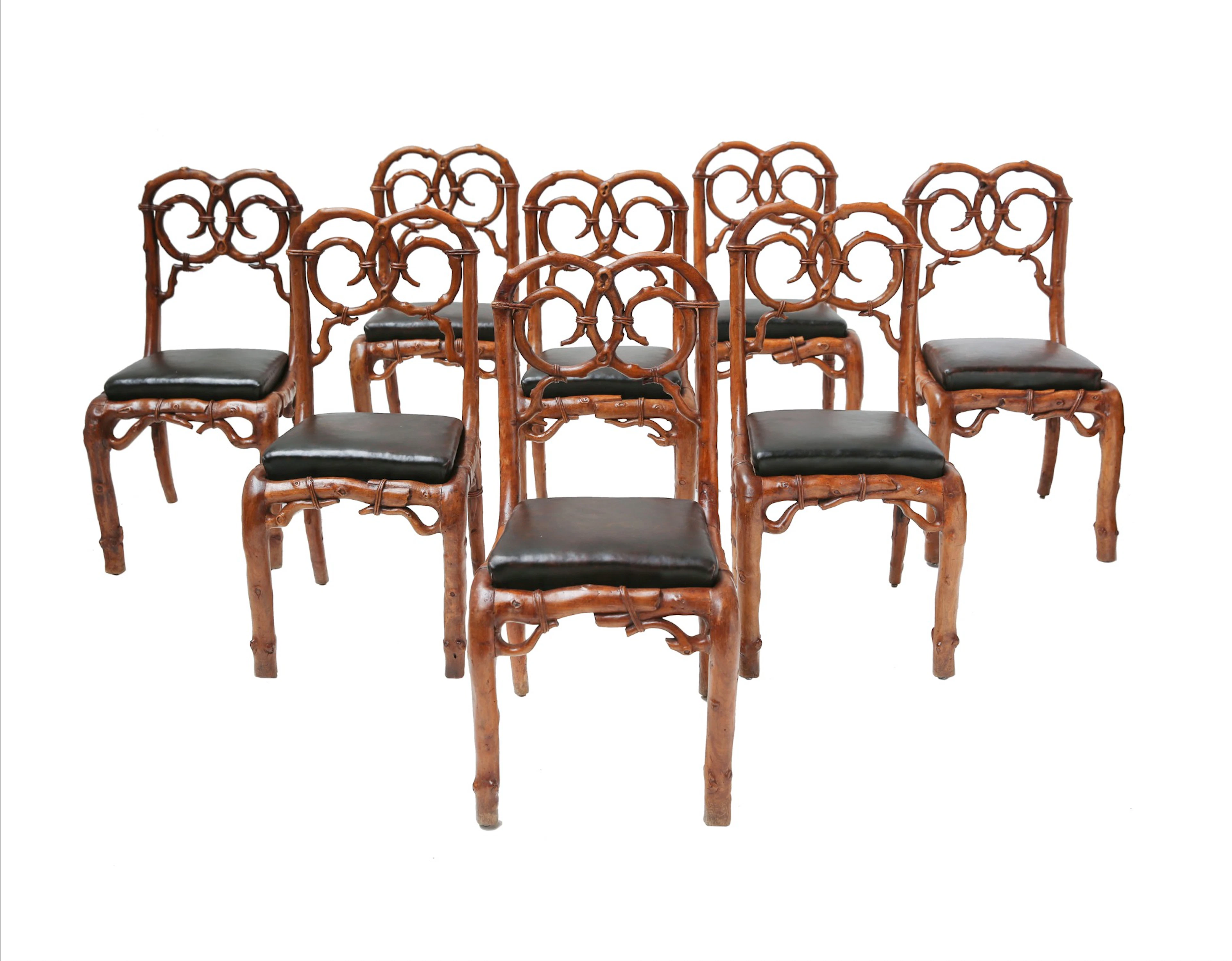 A suite of eight walnut rustic chairs