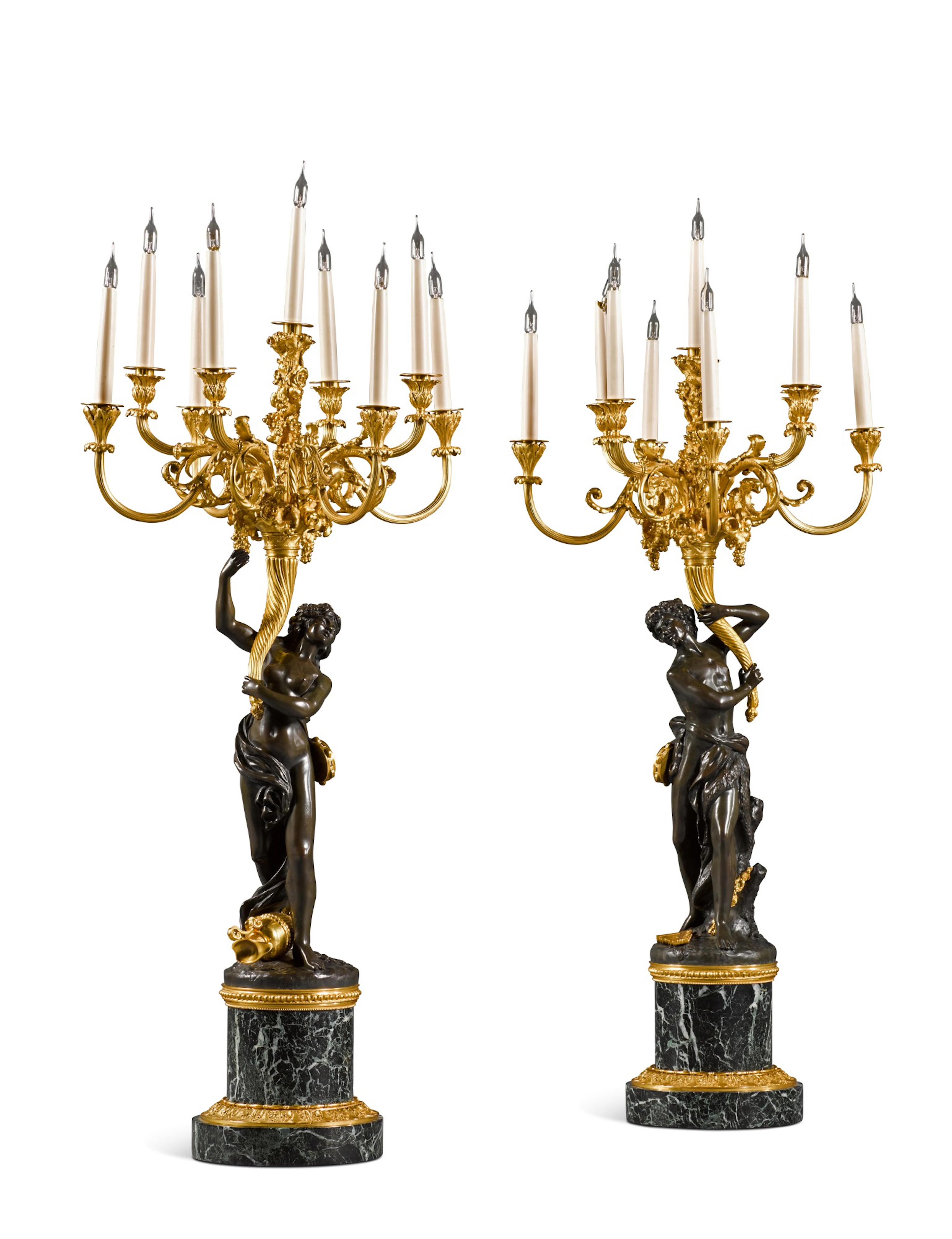 A pair of louis xvi style patinated and gilt-bronze ‘les...