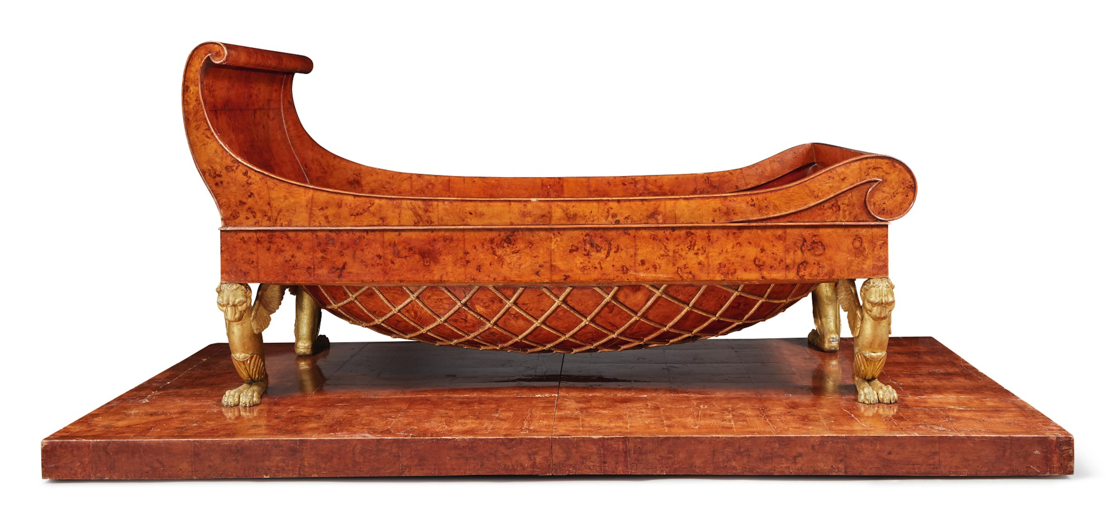 A tuscan neoclassical burr maple and parcel gilt daybed on plinth
