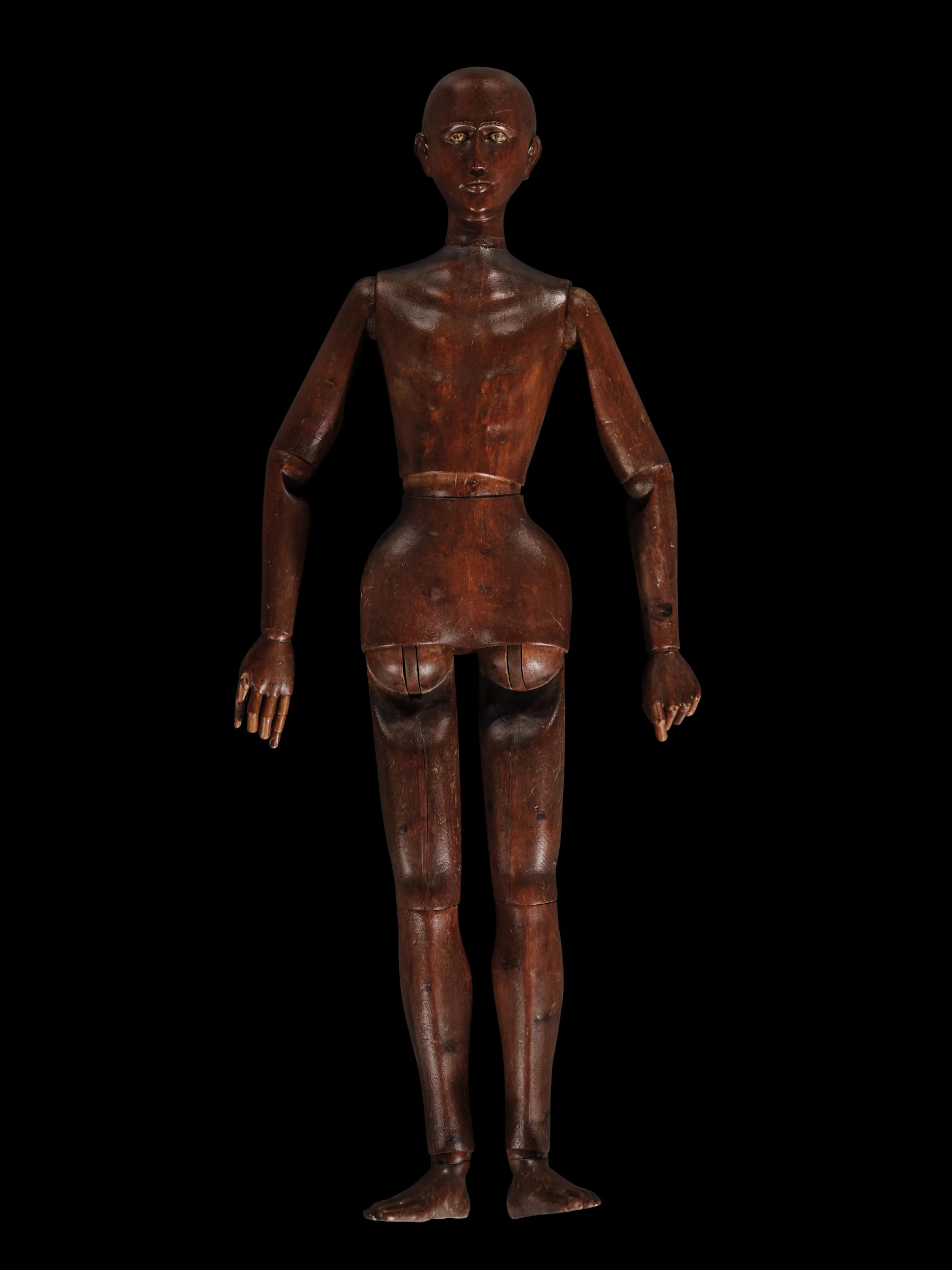 A carved oak lifesize and articulated artist's mannequin