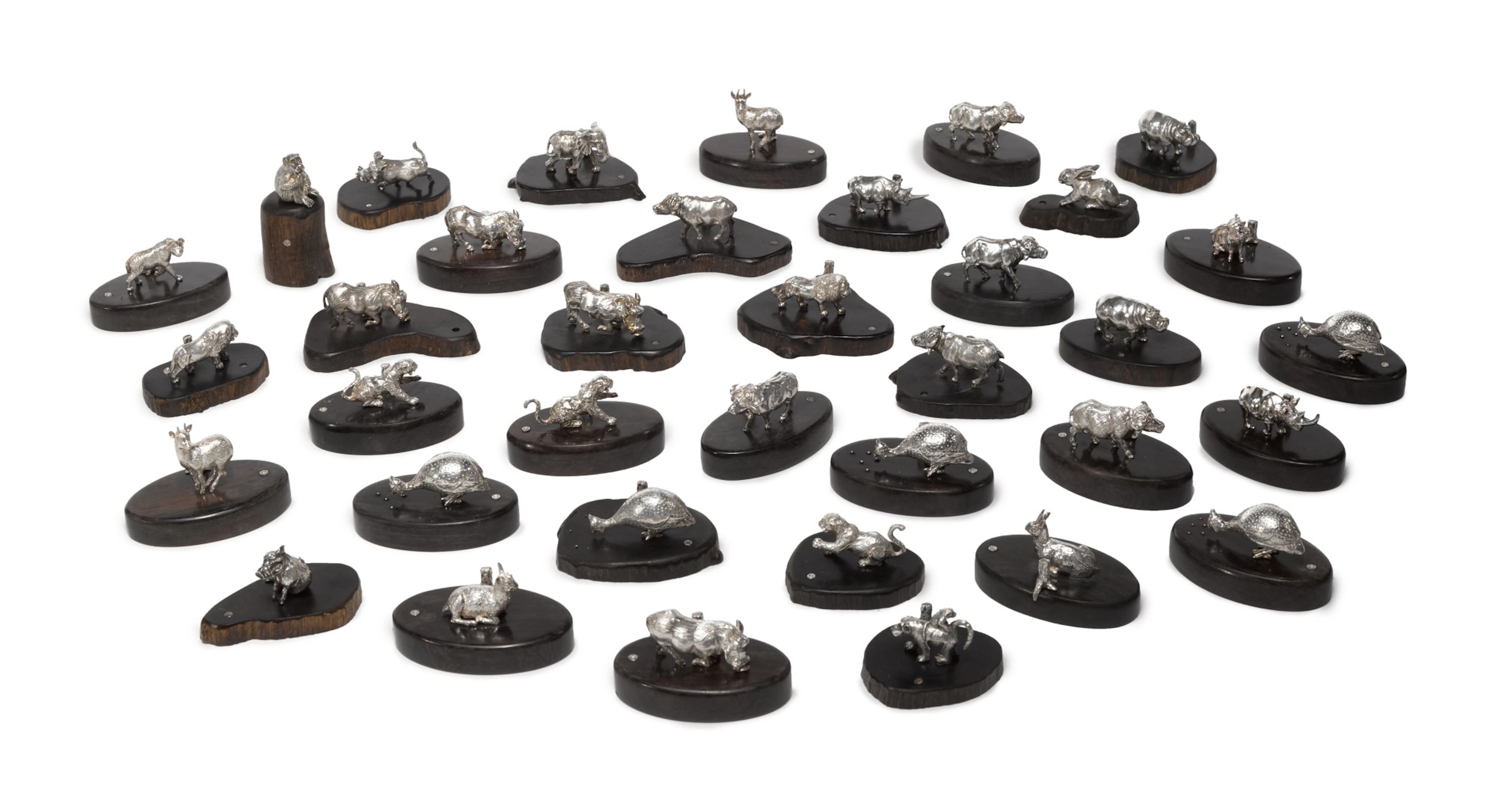 A Set of Thirty-Six Zimbabwean Silver and Wood Animal Place Card Holders