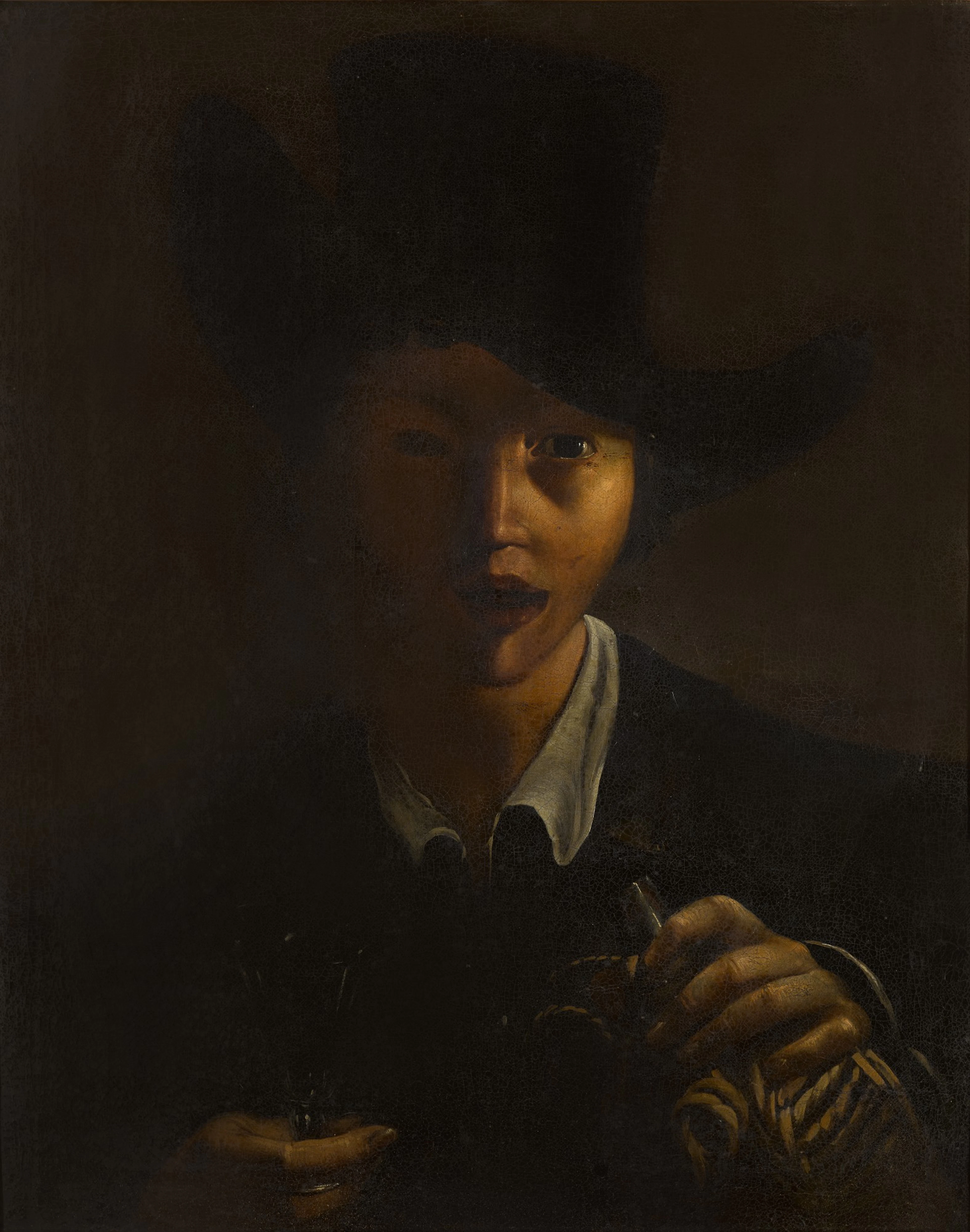 A young boy with a hat holding a wine glass and bottle