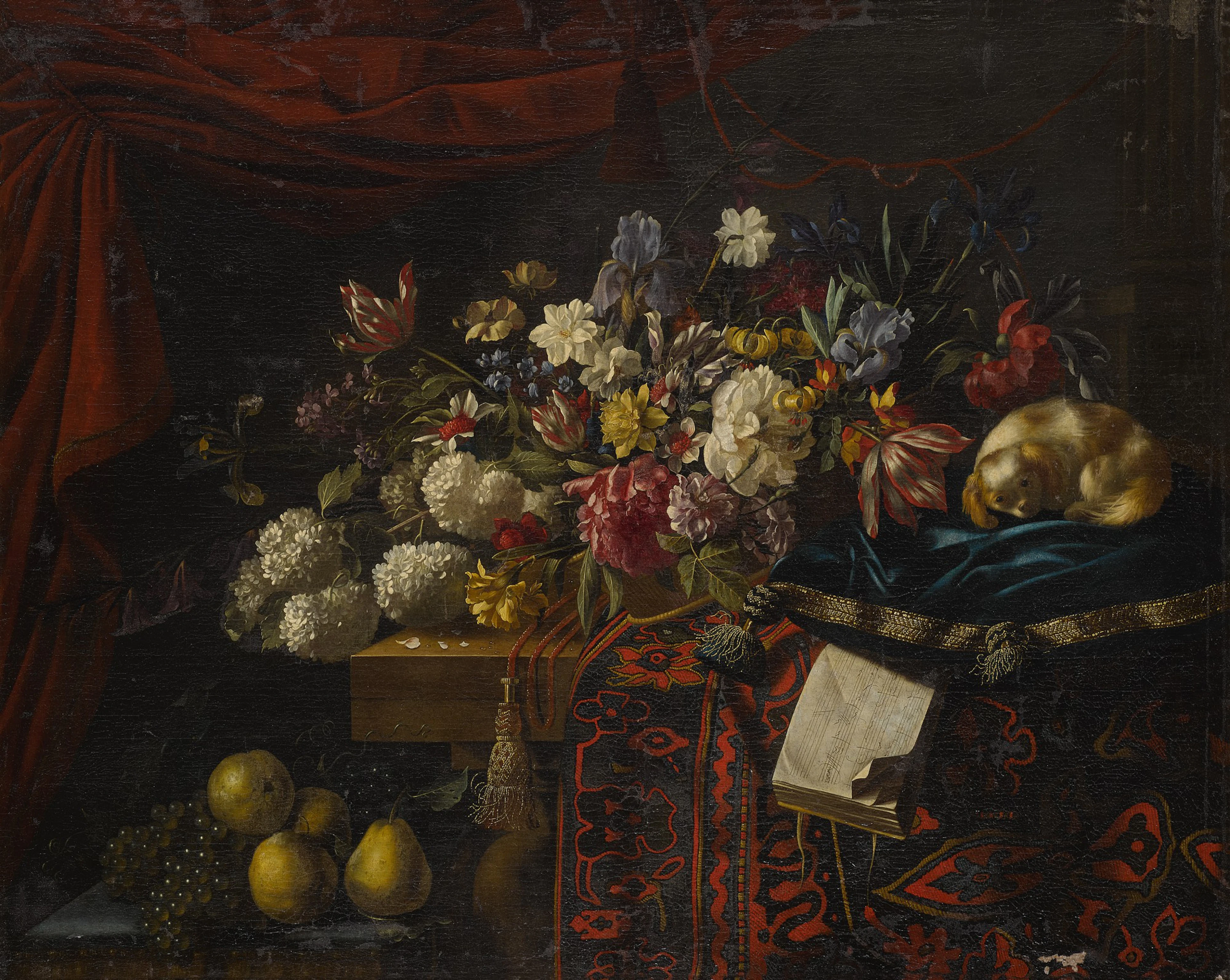 A still life of flowers set on a table with a carpet