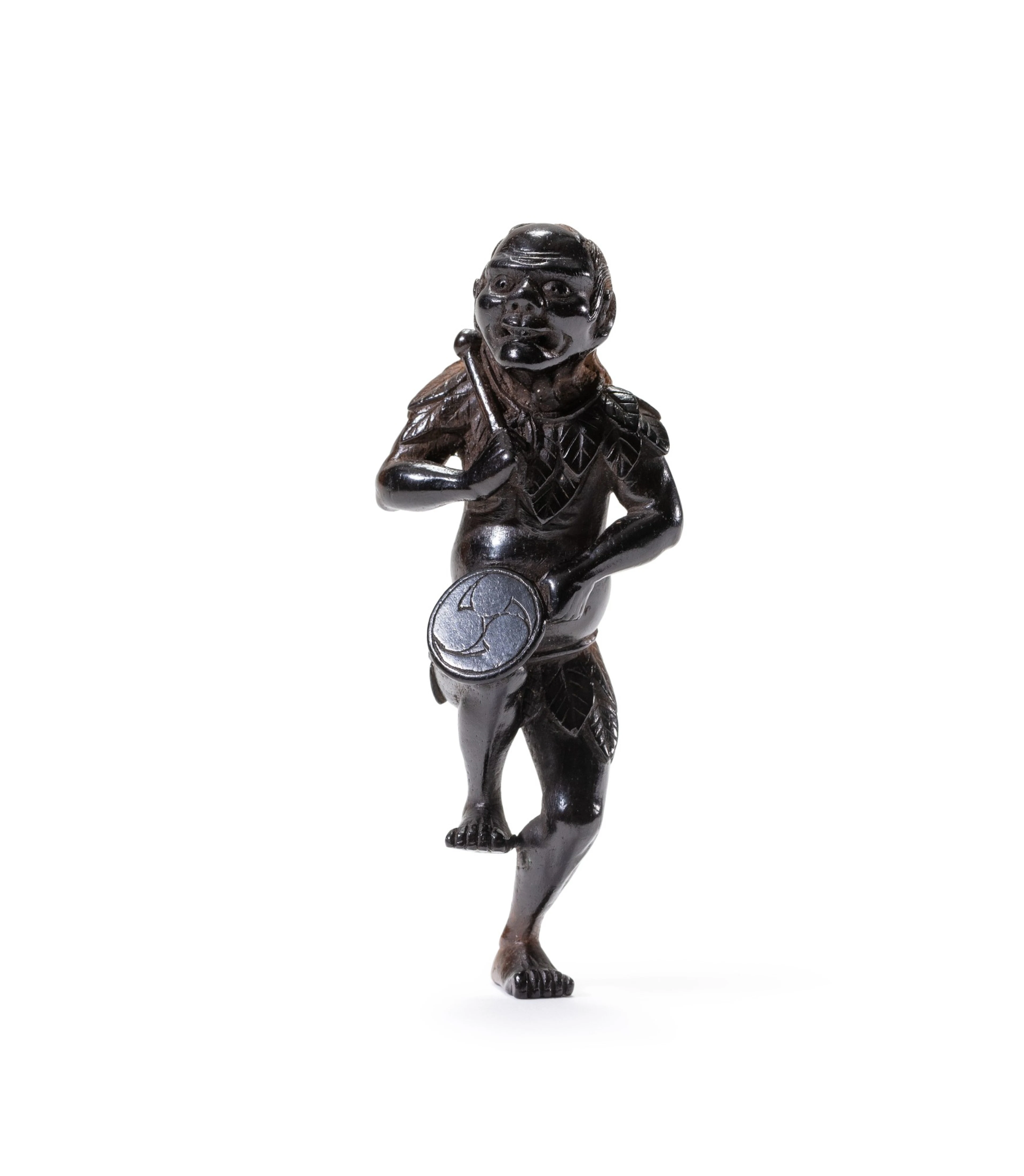 A carved wood study of a drummer